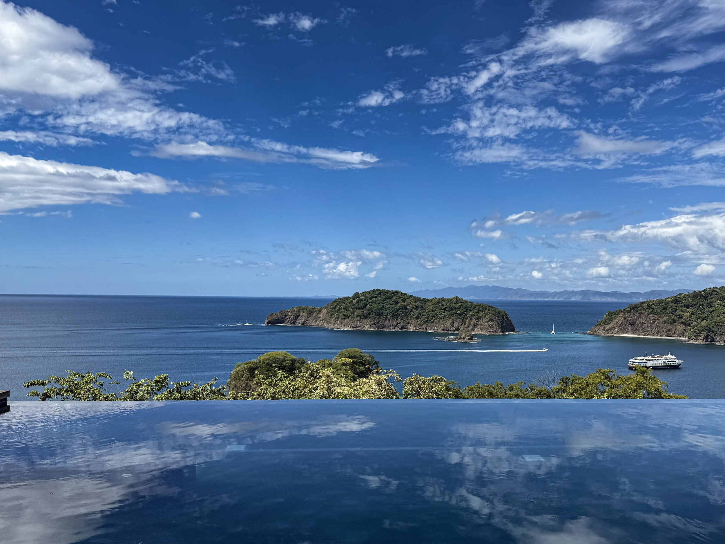 Infinity pool at Nekajui, a Ritz-Carlton Reserve, overlooking forested headlands and the Pacific on Peninsula Papagayo, Costa Rica