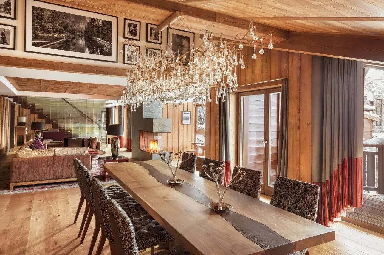 Dining room with chandelier and fireplace in The Apartment at Cheval Blanc Courchevel
