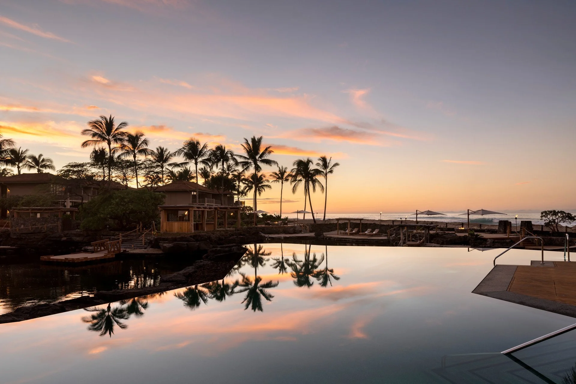 Sunset over the infinity pool at Four Seasons Hualalai on the Kona Coast of Hawaii Island