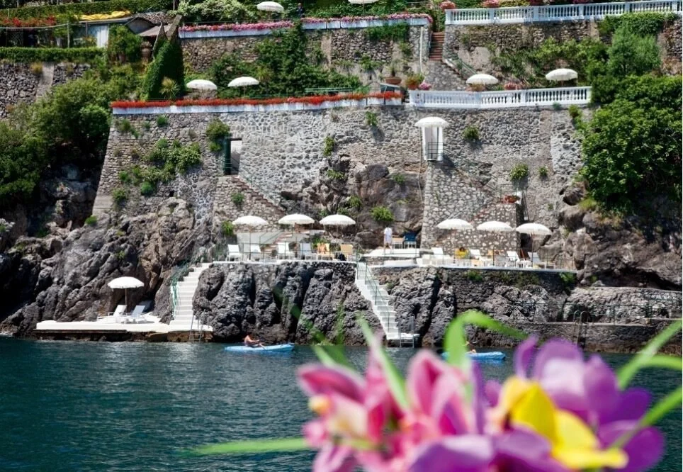 Red and white striped umbrellas on the terraces of the Clubhouse by the Sea at Marmorata below Ravello