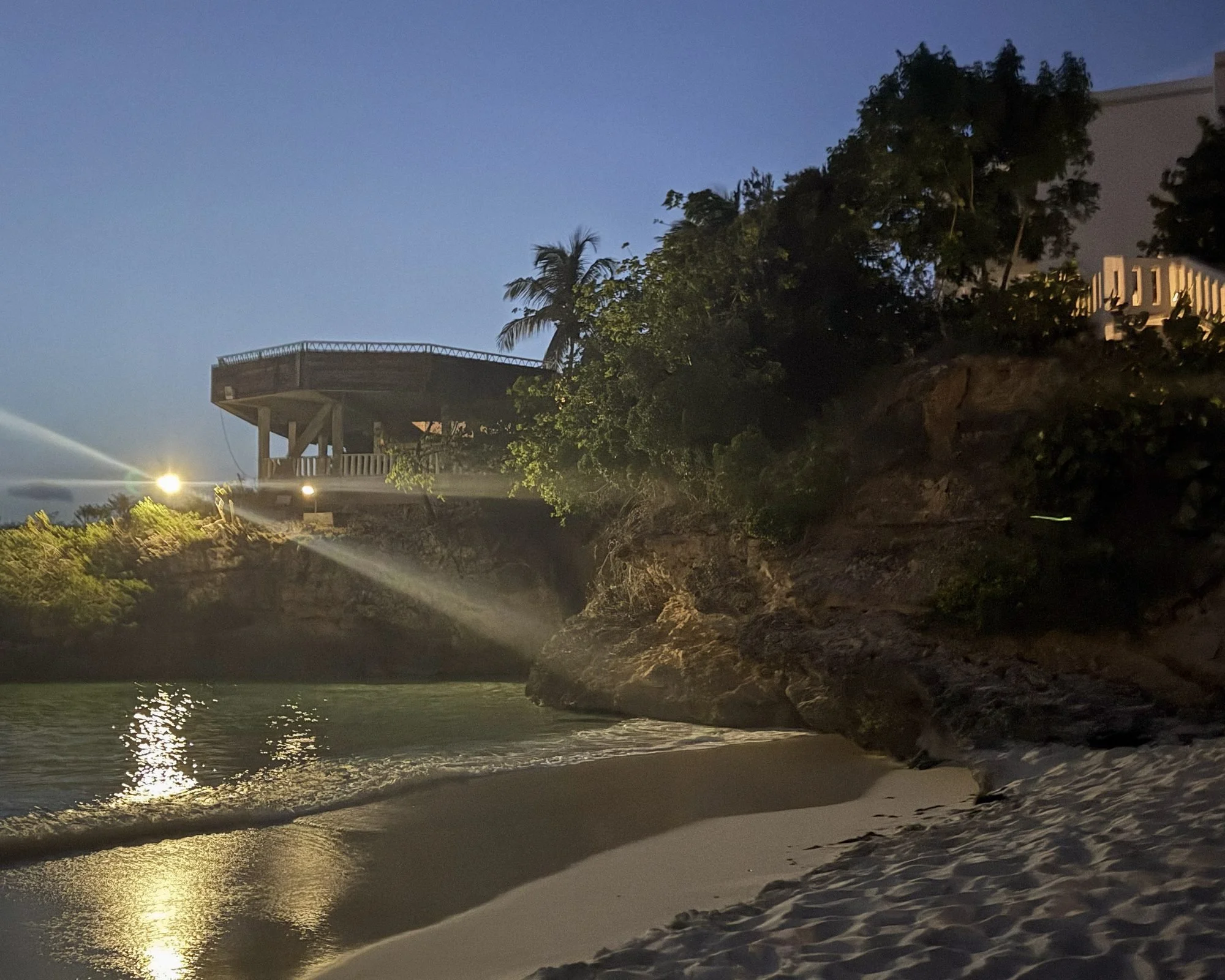 Exterior view of Celeste restaurant on the bluff at dusk from Meads Bay at Malliouhana Anguilla