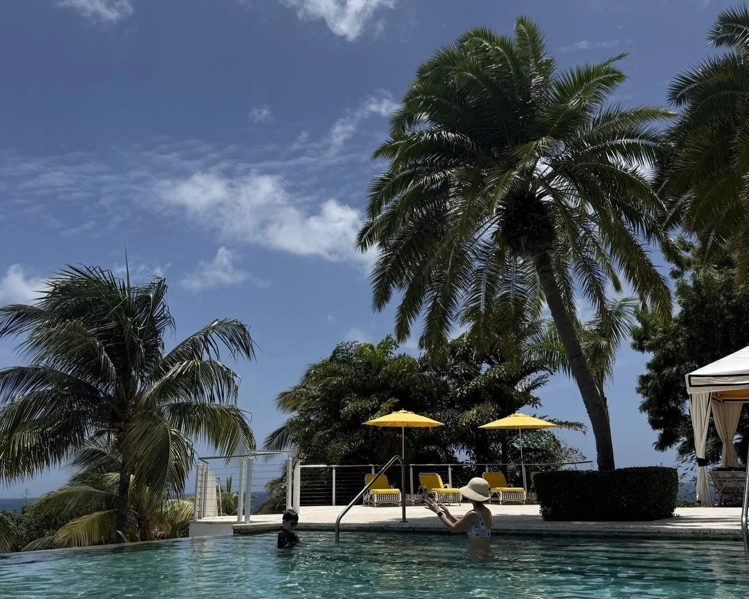 Author Kate Van Dell's son in the infinity pool looking out over Meads Bay at Malliouhana Anguilla