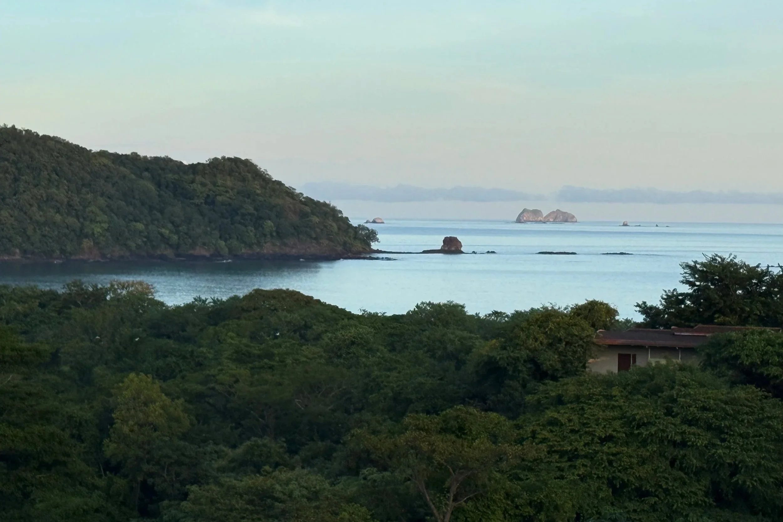 Panoramic ocean and forest canopy sunrise view from room balcony at W Costa Rica