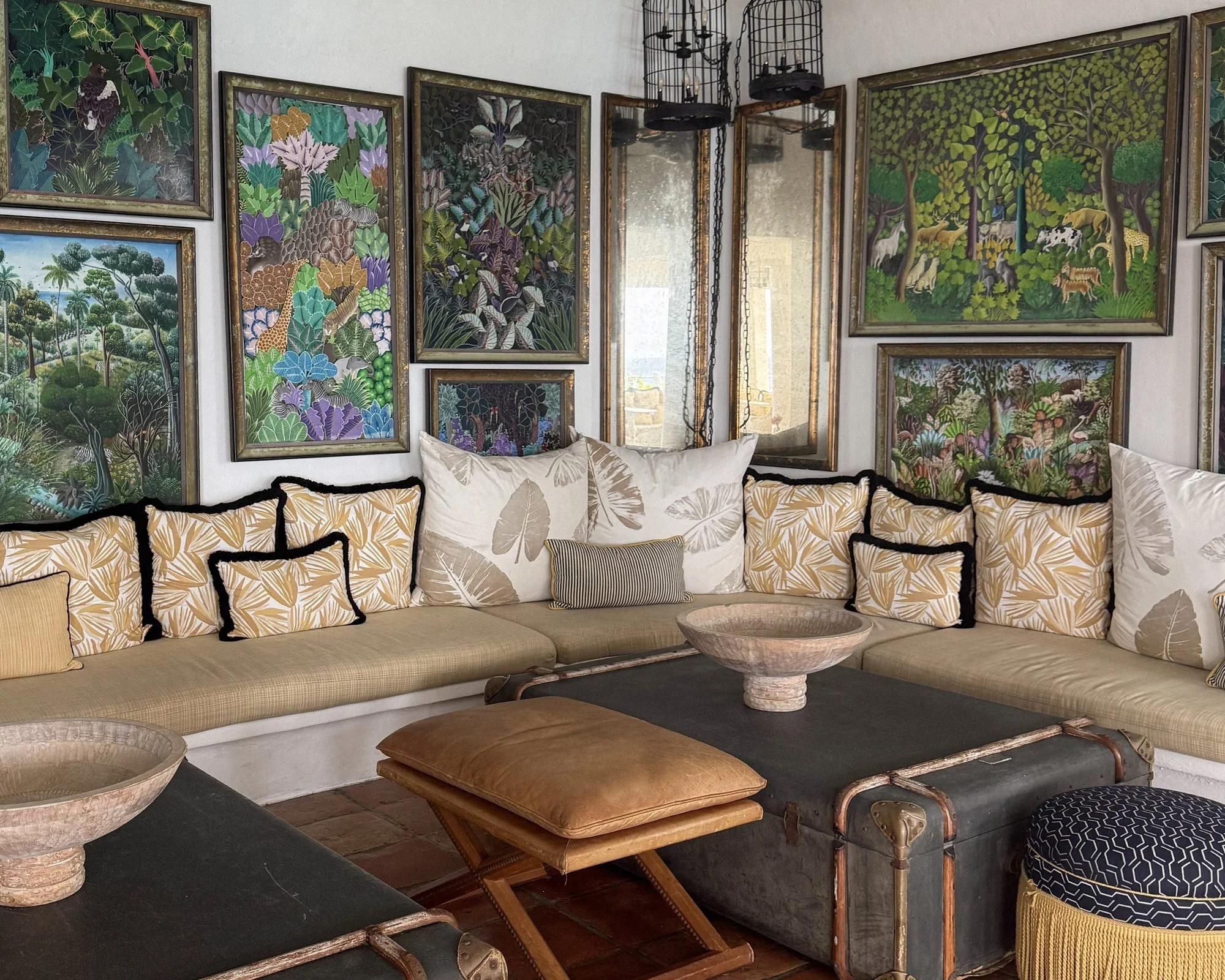 Lounge with framed Haitian jungle paintings at Malliouhana Anguilla