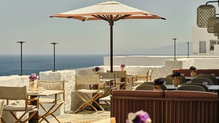 Restaurant terrace with sea views and outdoor seating at Four Seasons Hotel Mykonos