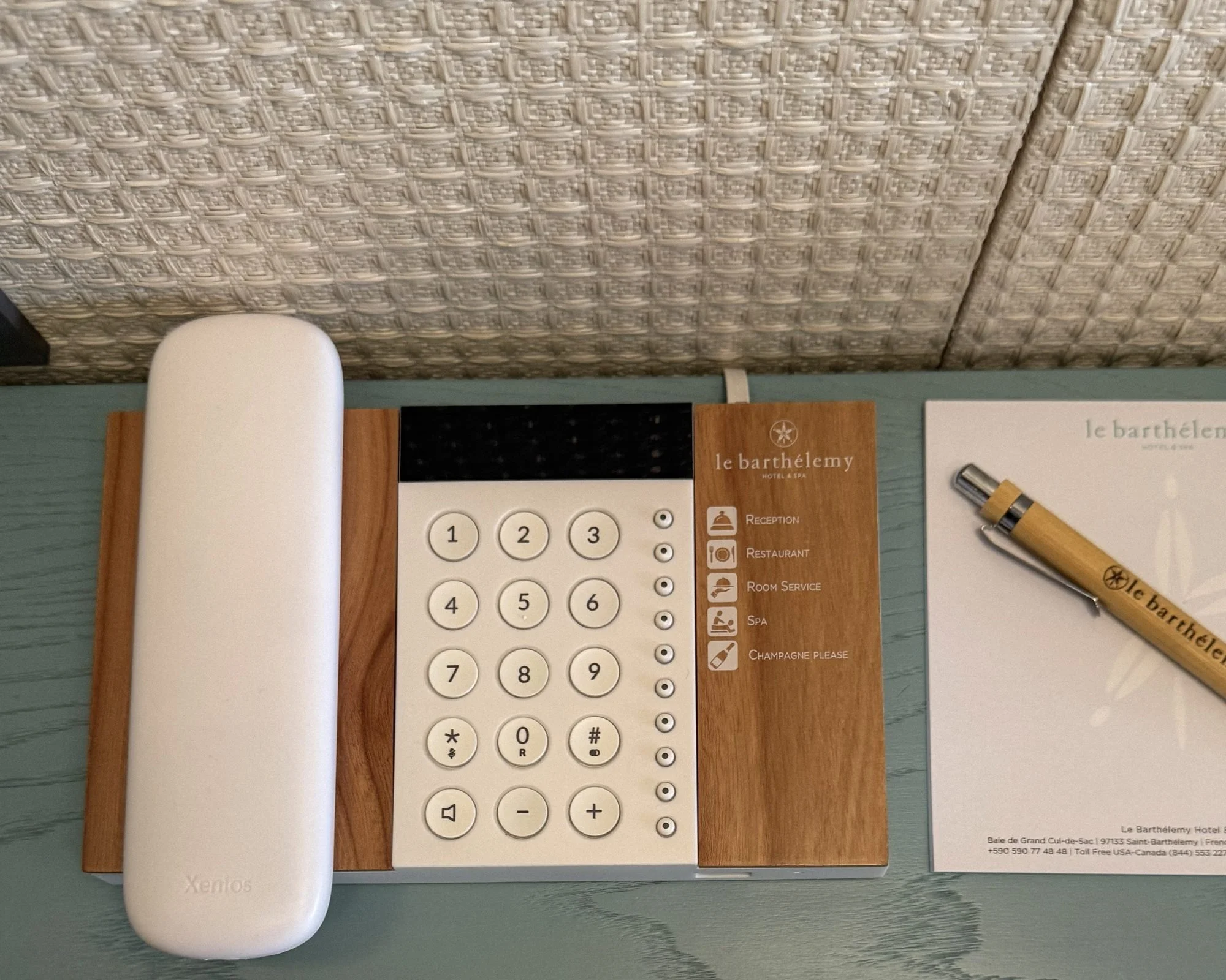 In-room telephone with a dedicated Champagne Please button at Le Barthélemy St. Barth