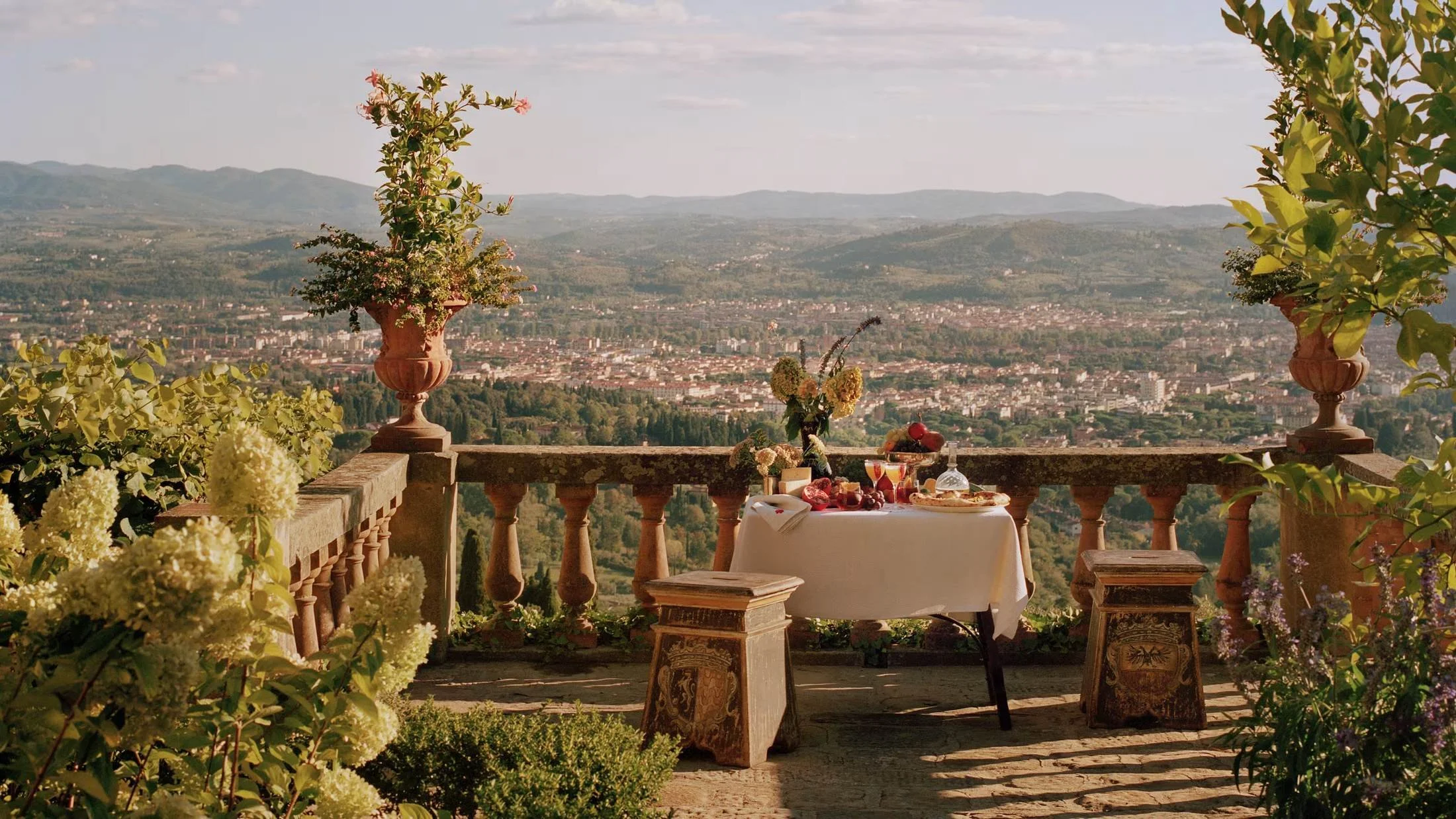 Terrace table set for lunch at Villa San Michele, A Belmond Hotel, overlooking Florence from Fiesole