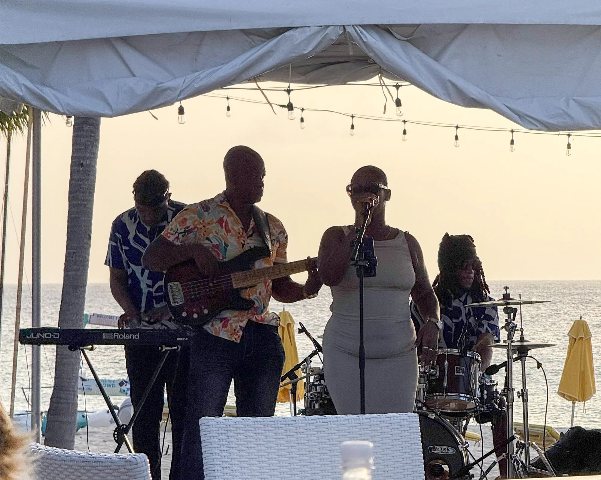 Live music on the beach with Mystic Vibes as the sun drops into Meads Bay.