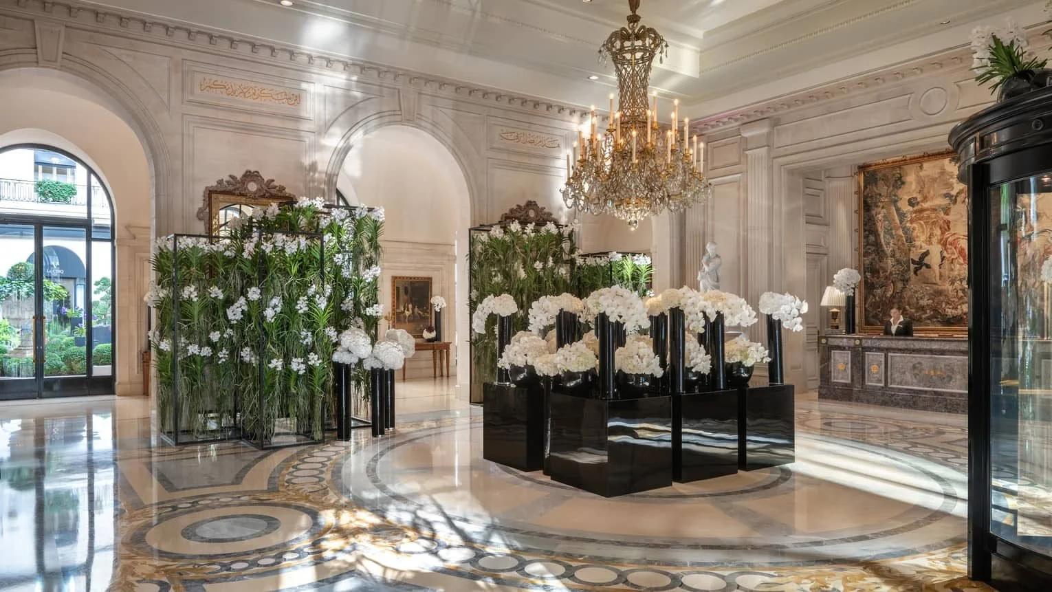 Marble courtyard at Four Seasons Hotel George V in Paris, set with pink orchid installations