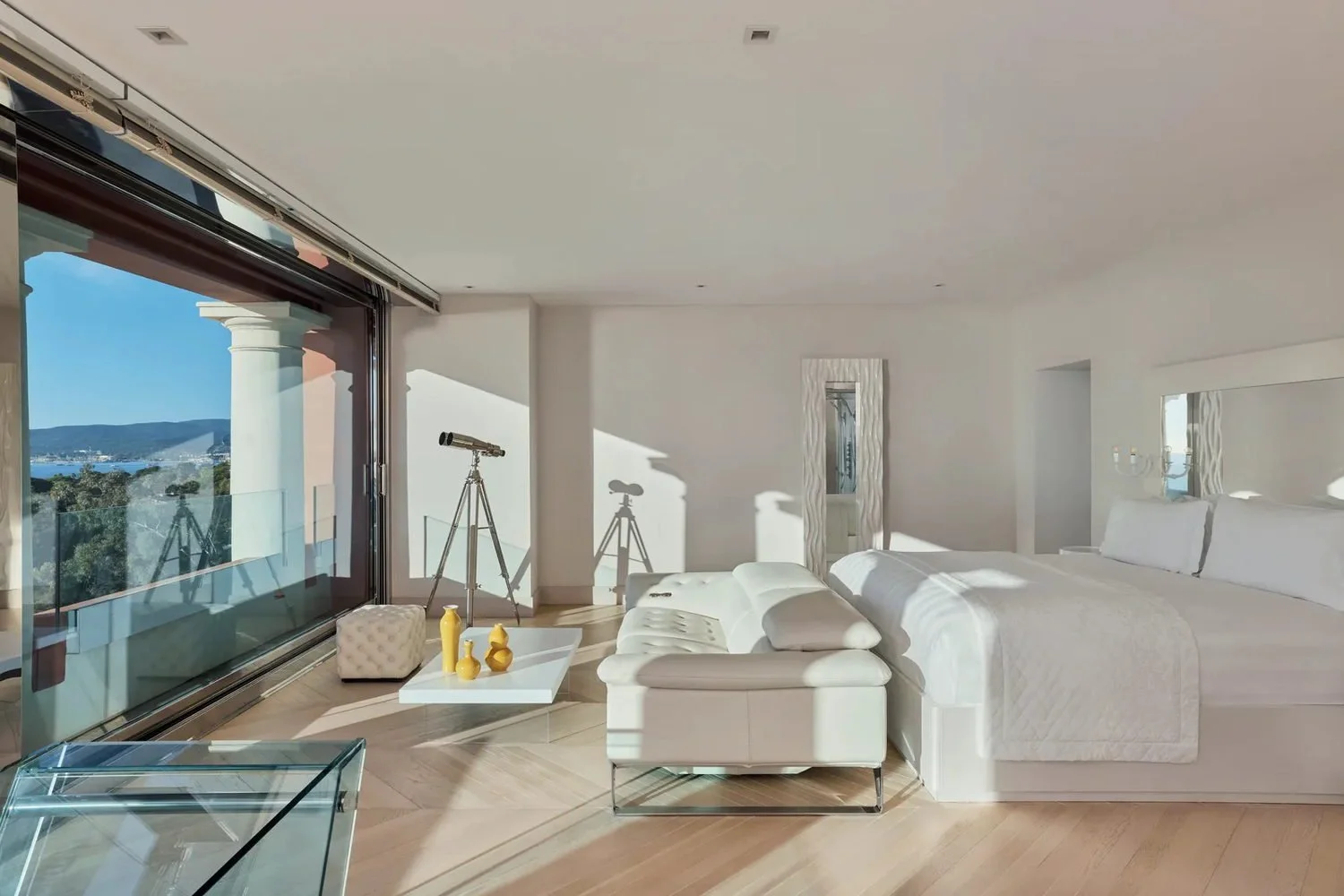 Contemporary suite bedroom with open-plan layout at COMO Le Beauvallon