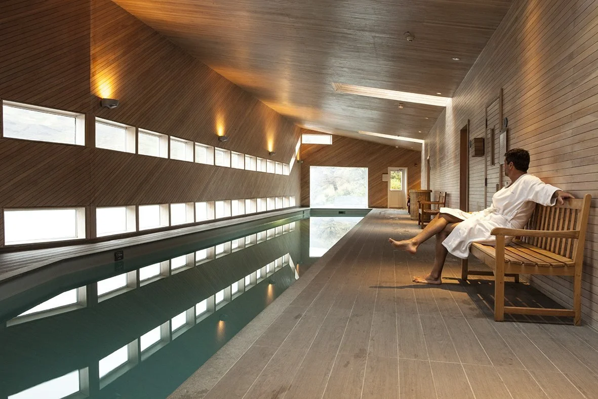Heated indoor lap pool at Explora Patagonia’s Casa de Banos spa, lined in pale timber