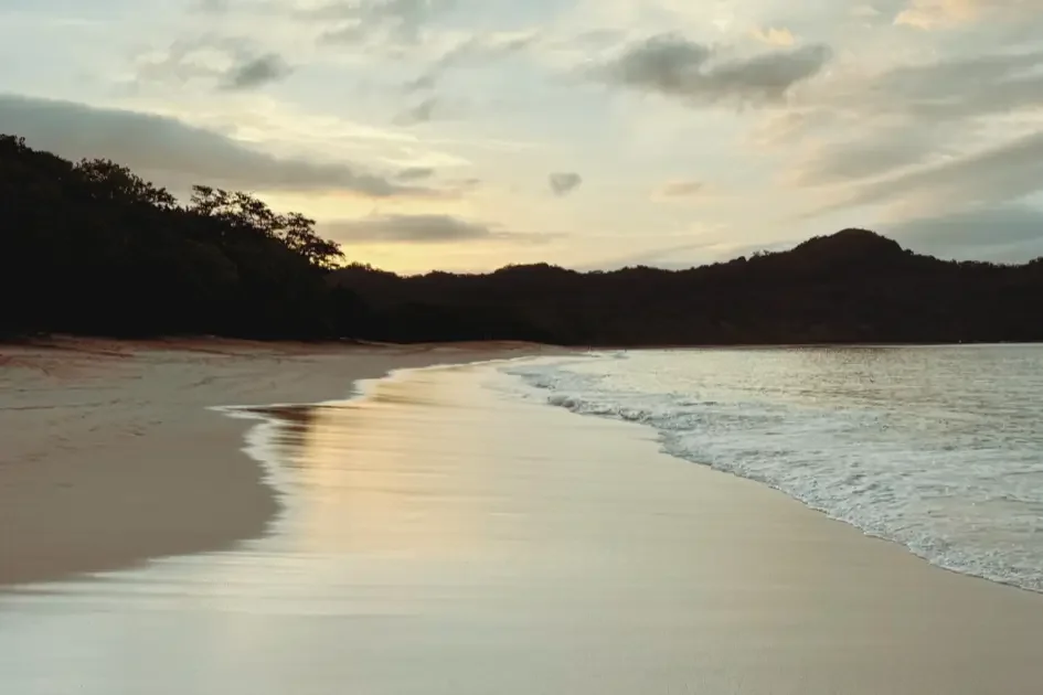 White crushed-shell shore and clear turquoise water at Playa Conchal, W Costa Rica