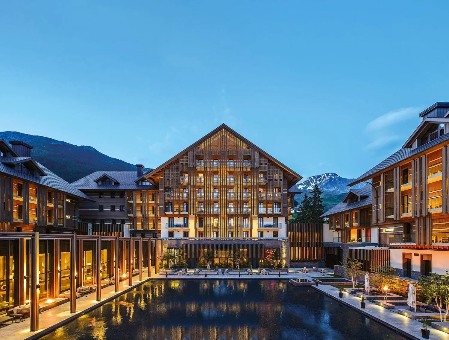 The Chedi Andermatt reflecting pool and exterior at dusk