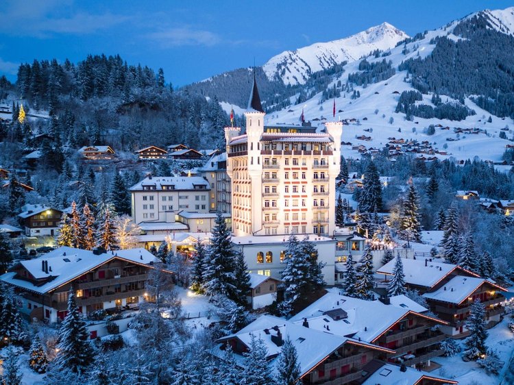 Gstaad Palace lit up on winter evening