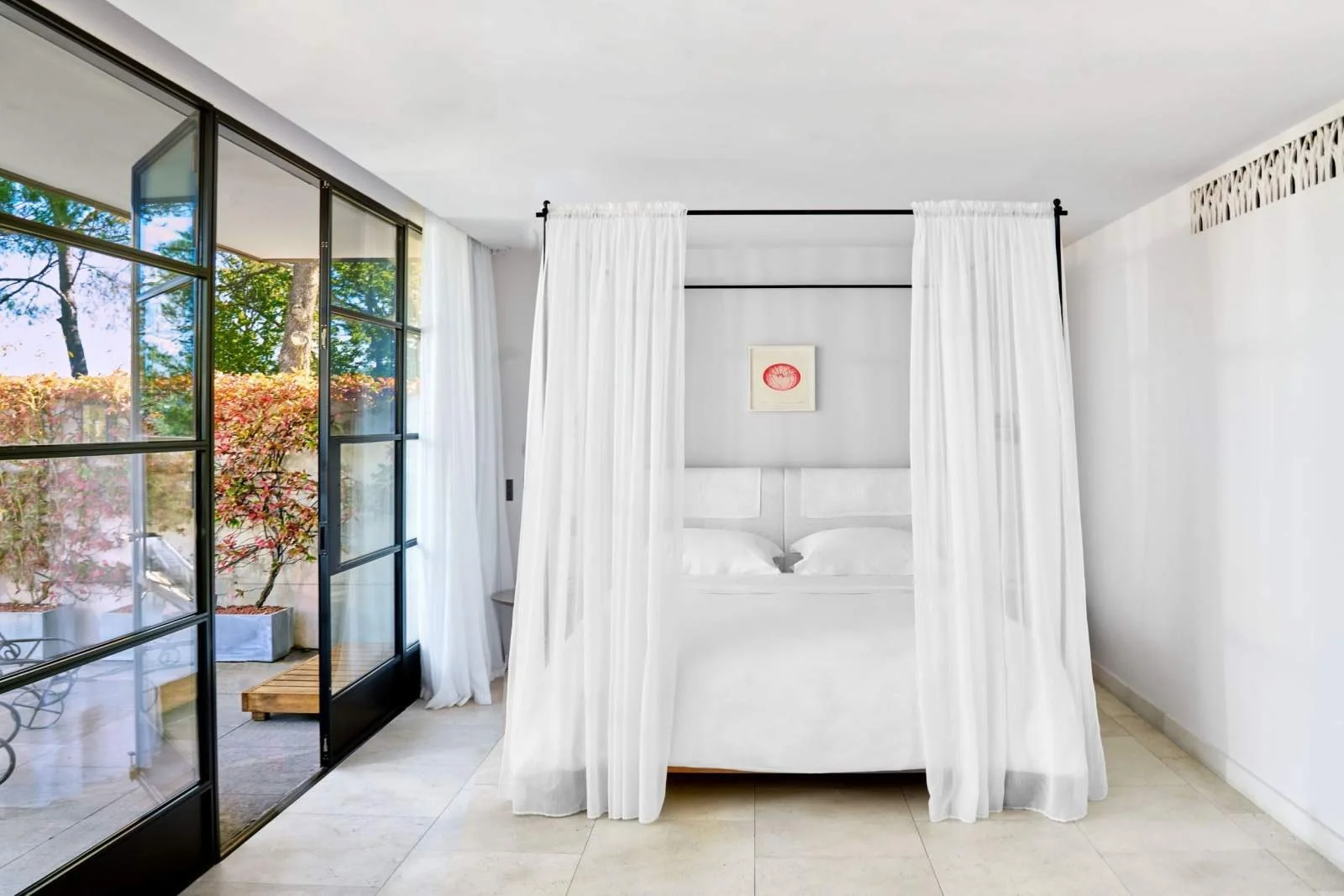 Villa La Coste hotel building and outdoor pool set into the hillside above the vineyards, Provence.