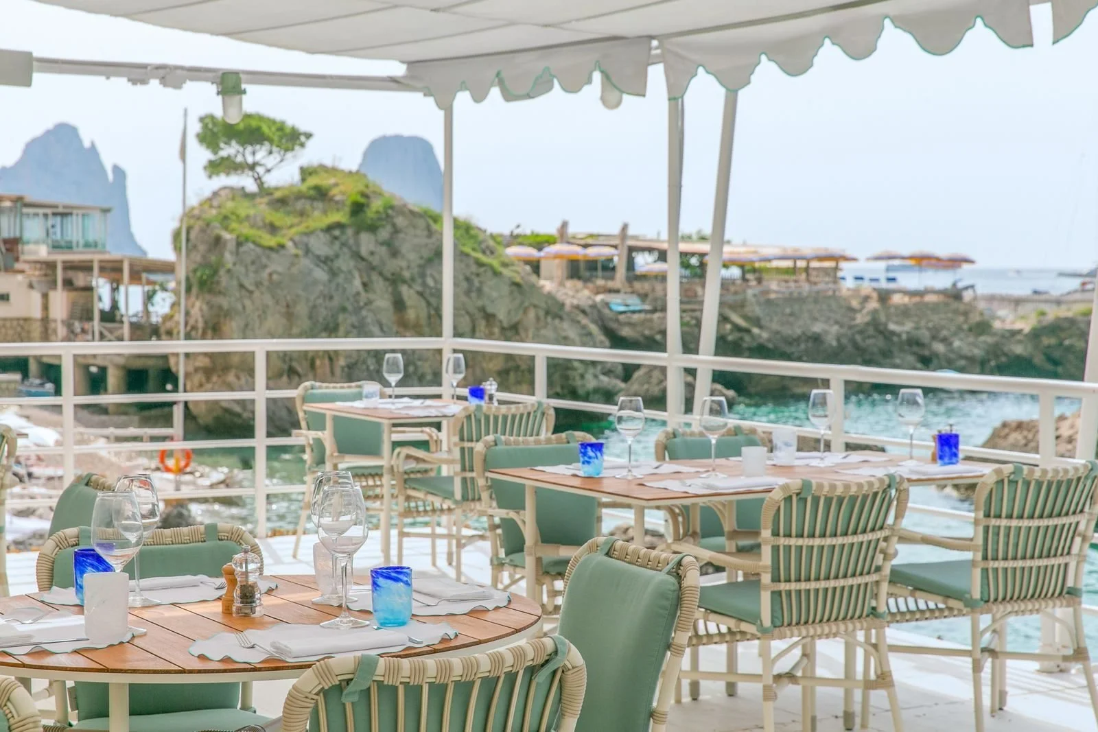 Dining terrace at Mare by Casa Tua at Marina Piccola on Capri, with the Faraglioni in the distance