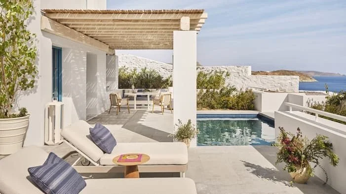 Private pool and shaded terrace at a Four Seasons Hotel Mykonos villa, looking out over Kalo Livadi Bay