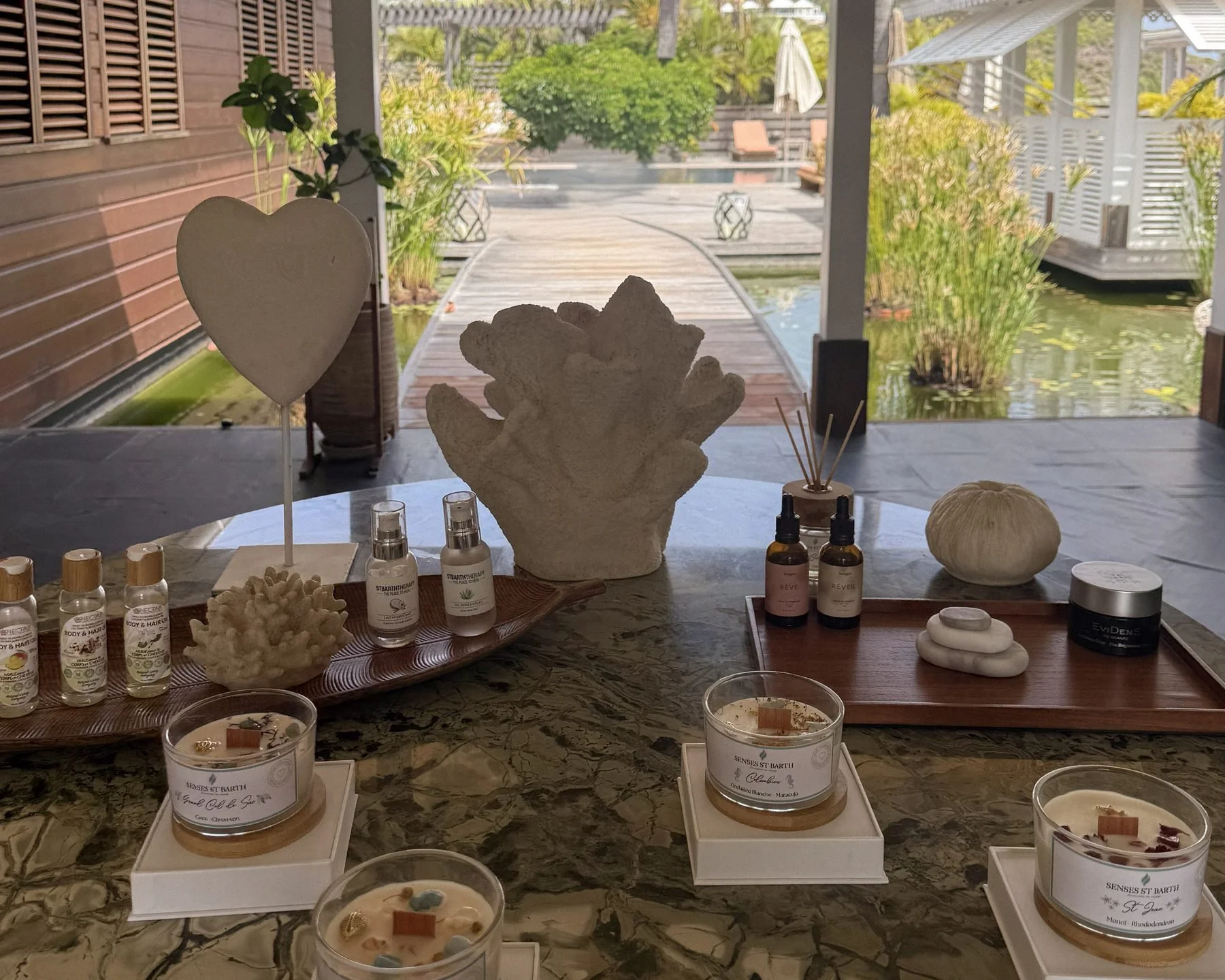 Luxury spa products and beach-inspired scented candles displayed at Sense Spa.