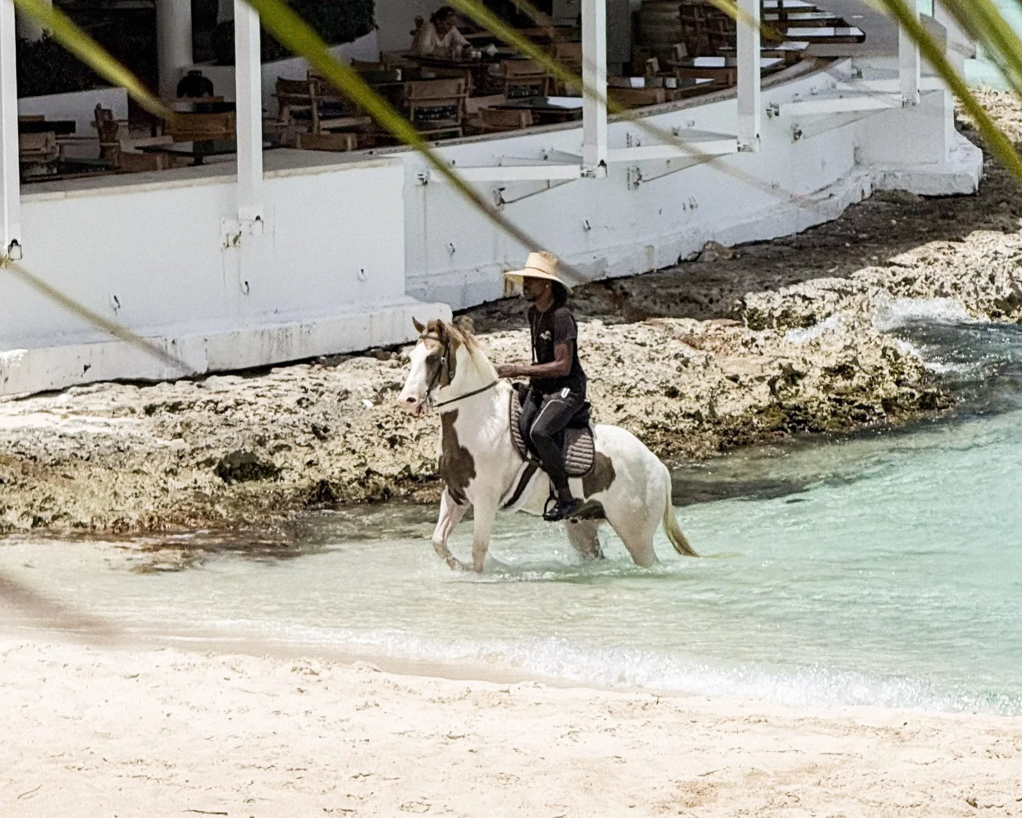 Horseback rider in the shallows at Maundays Bay Cap Juluca Anguilla