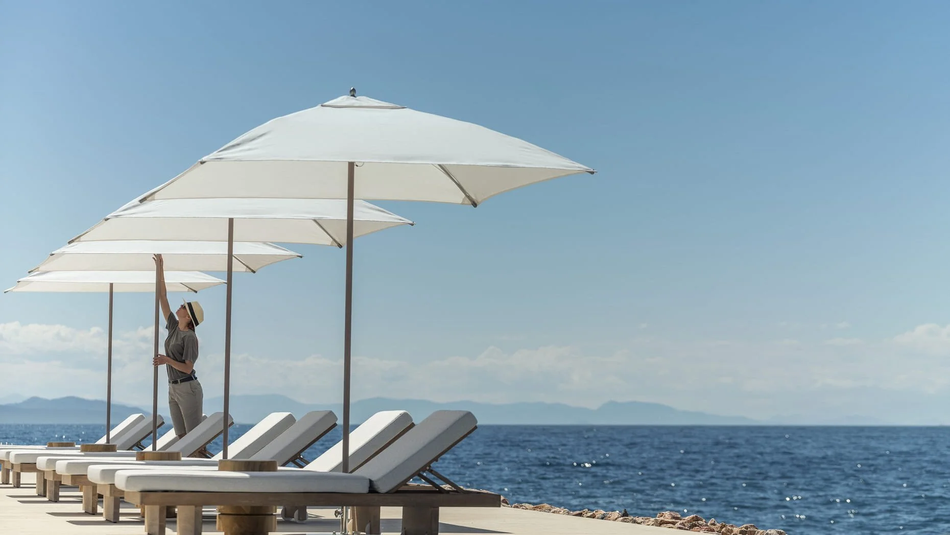 Loungers and umbrellas on a private beach at Four Seasons Astir Palace Athens