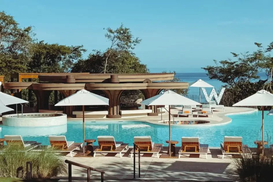 Adults-only pool framed by tropical greenery at W Costa Rica Reserva Conchal