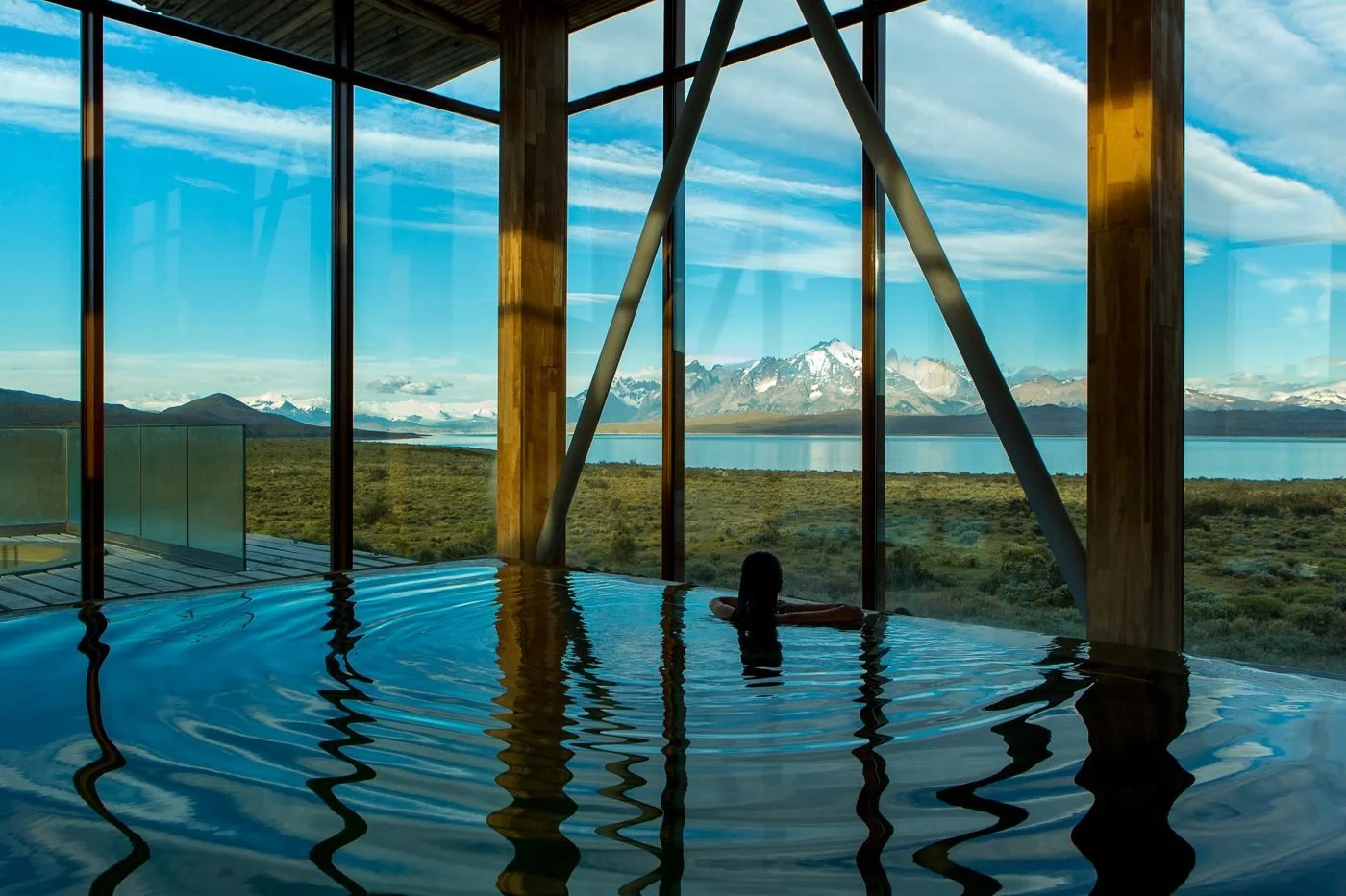 Heated indoor pool at Tierra Patagonia’s Uma Spa looking across Lake Sarmiento to the Paine massif