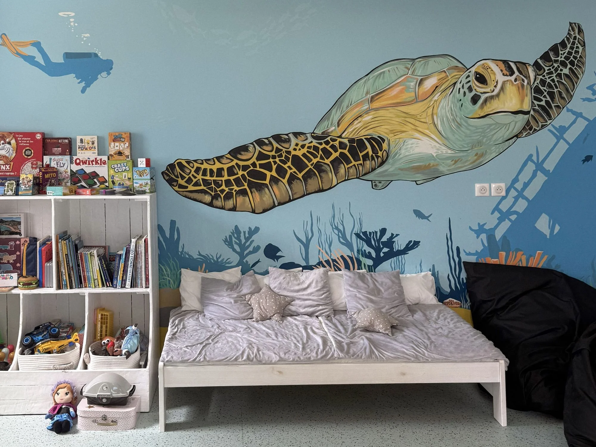 Colorful interior of the Rosewood Explorers Kids Club with wall murals and activity areas.