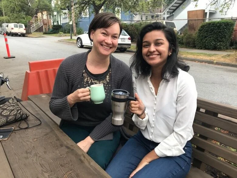   Jenny van Enkevort (left) and Abeer Yusuf from Mount Pleasant Neighbourhood House share the new parklet community space together. (Margaret Gallagher/CBC)  
