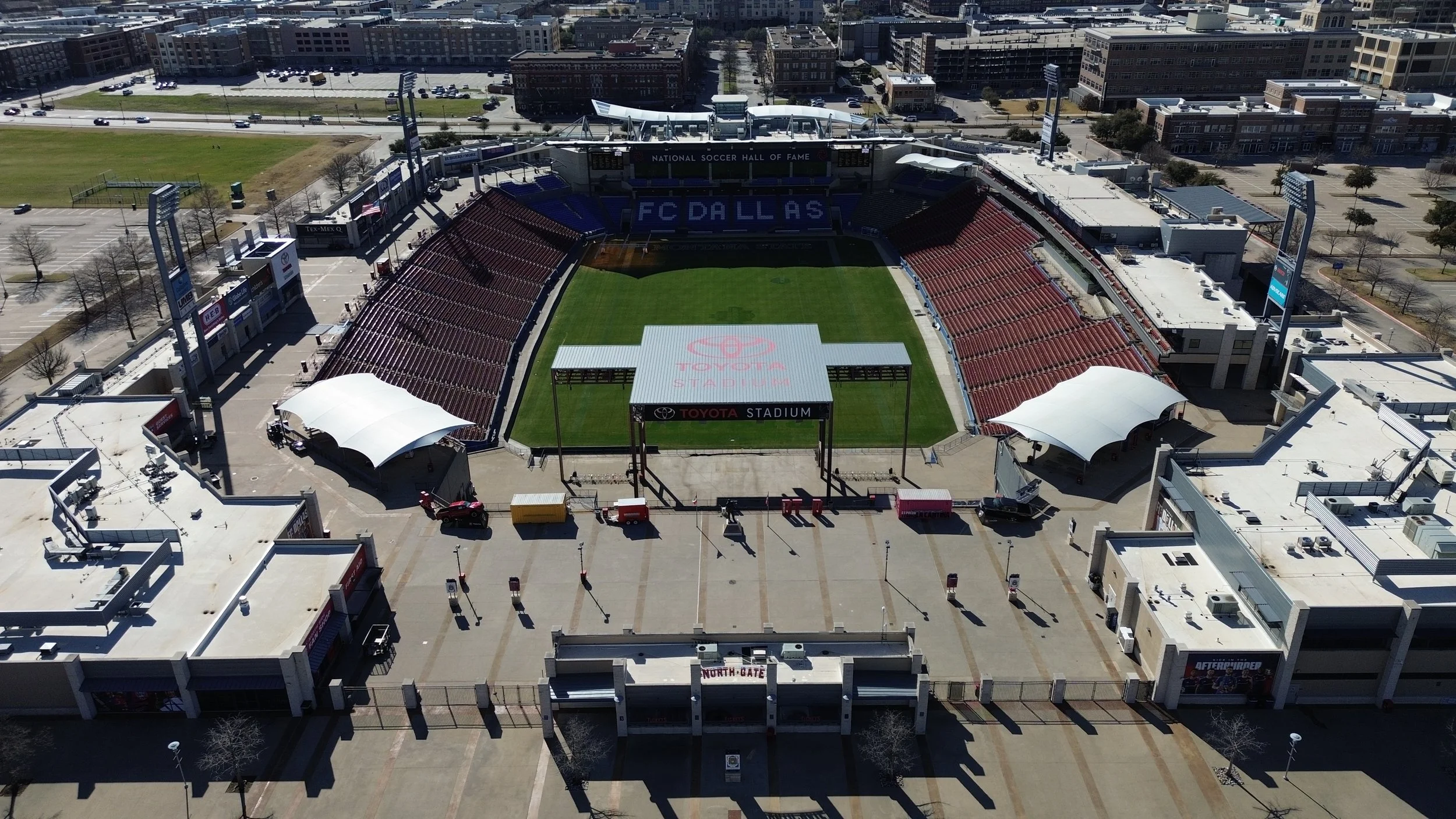 Aerial view of a soccer stadium with FC Dallas branding and surrounding cityscape.