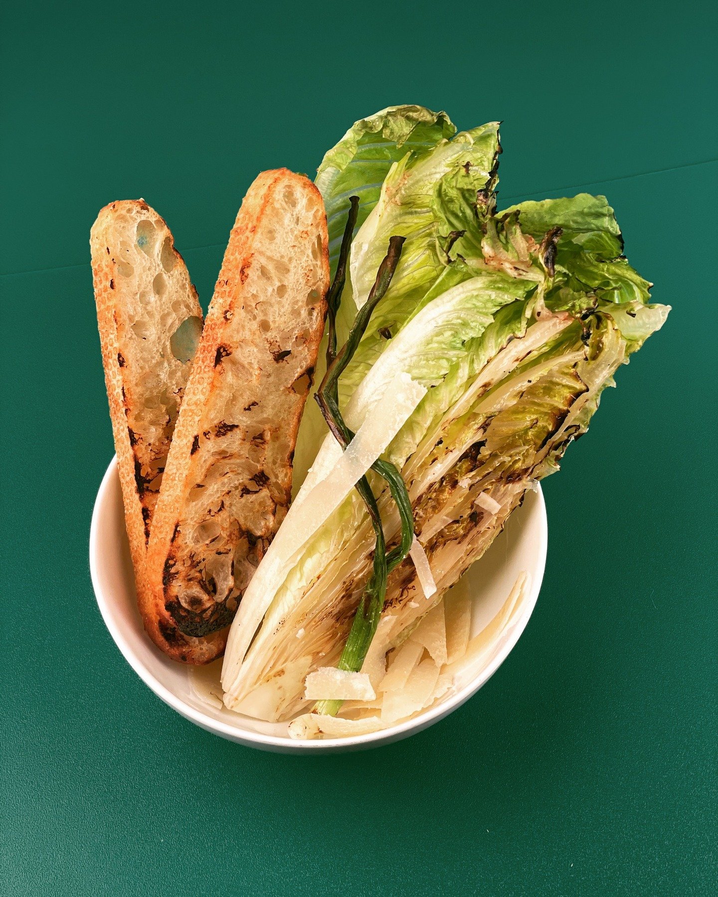 Charred Caesar salad - scallions and grilled house made sesame bread... shaved parm 😊