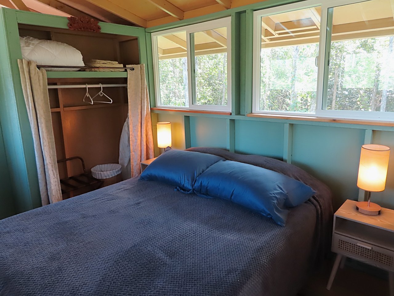Cozy bedroom environment. Queen size bed with organic cotton sheets. Lots of windows.