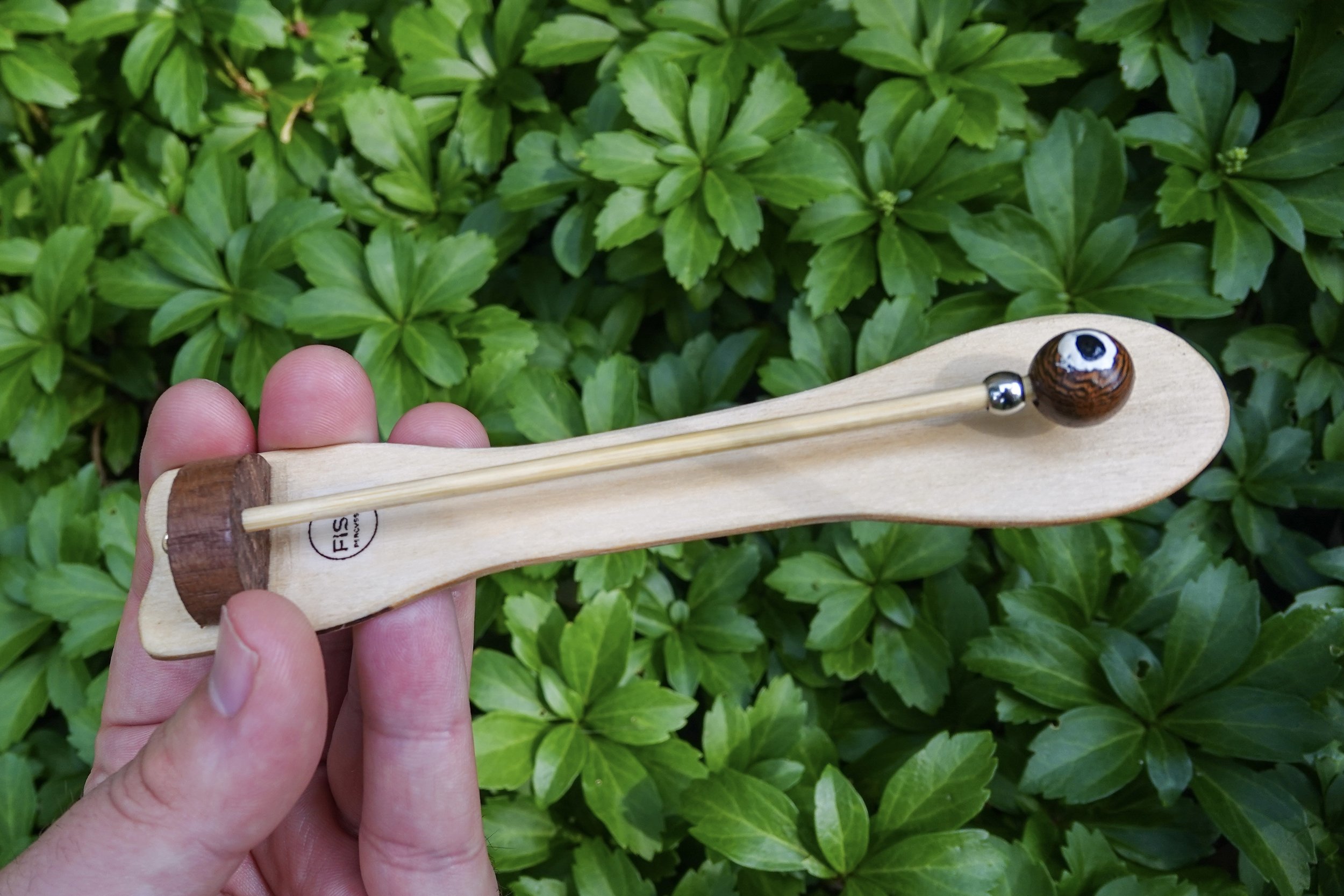 This Fish Drum has a brown eyeball mallet and a bamboo mallet