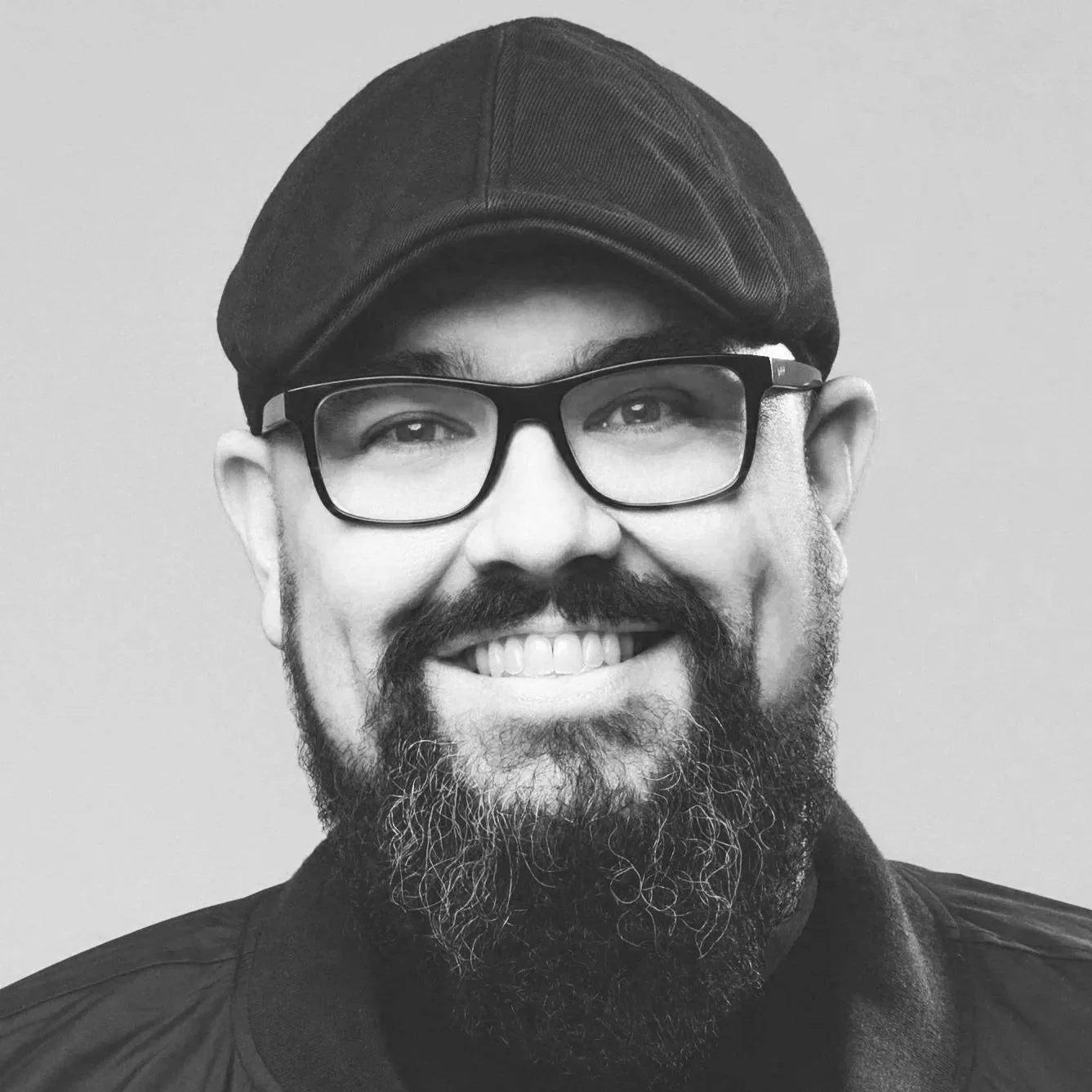 A smiling man with a beard named Mike Weaver, wearing glasses and a cap. He is the singer in the Christian band Big Daddy Weave.