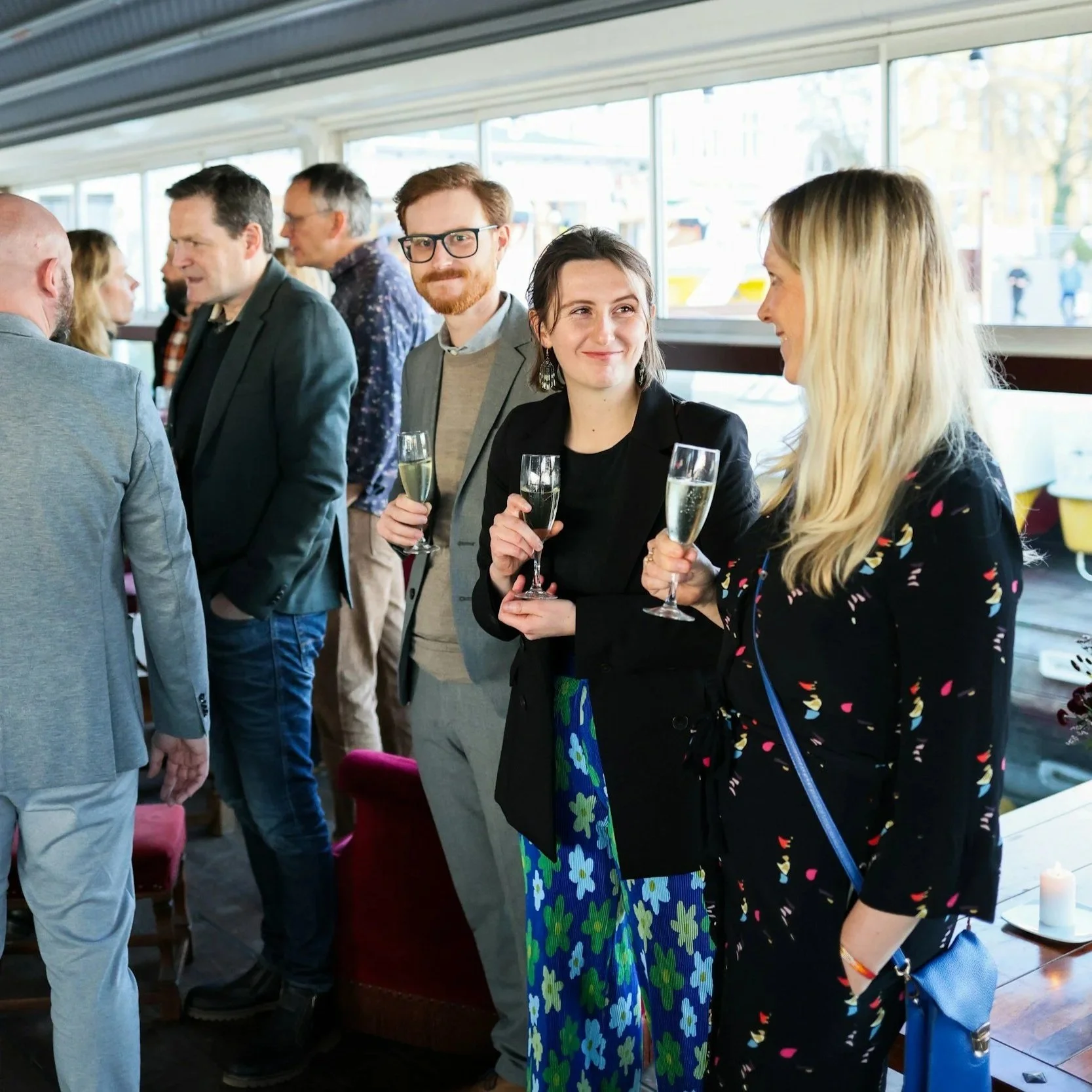 Professionals networking with wine glasses during a corporate wine tasting event in New York City