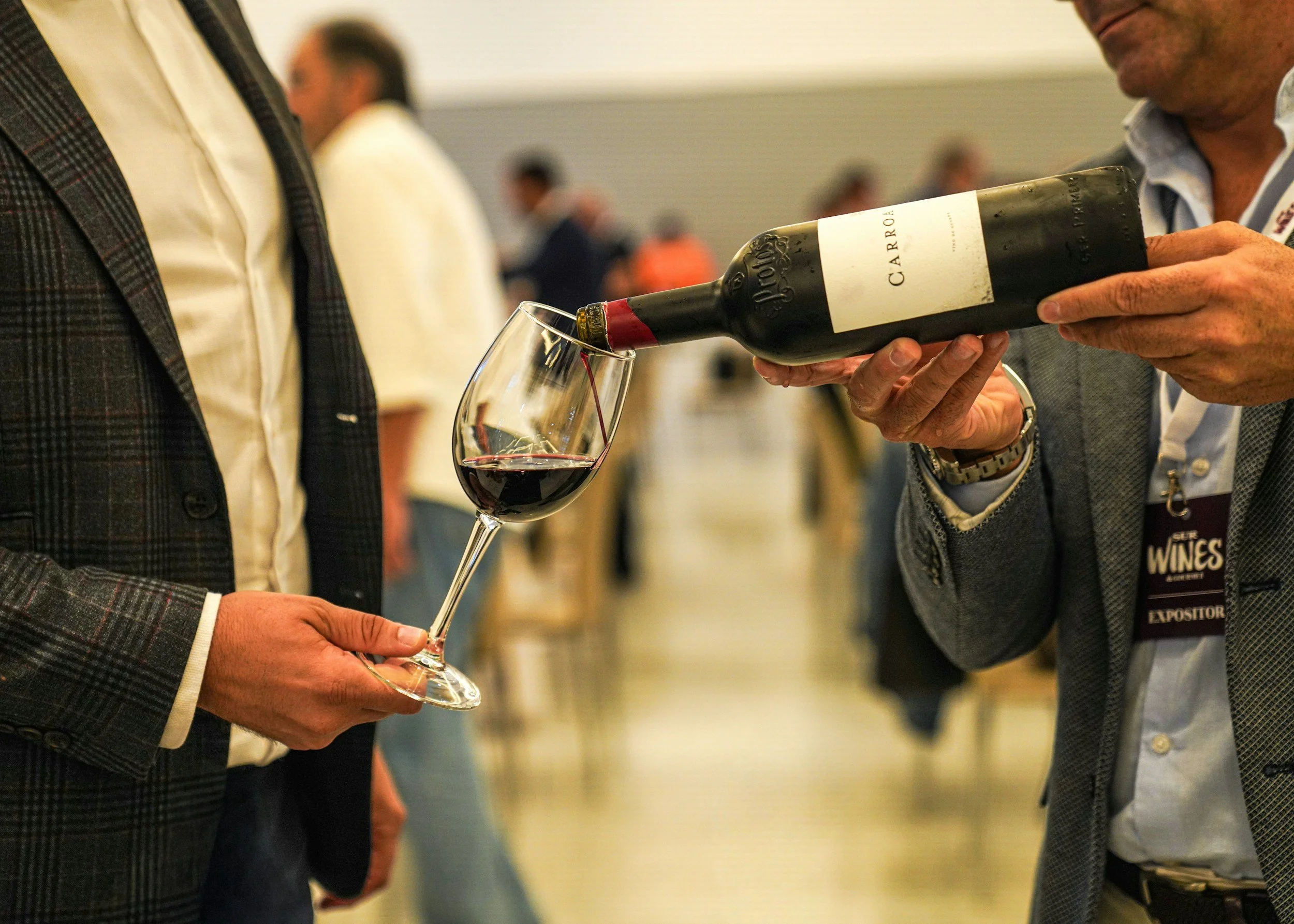 Red wine being poured into a glass at a corporate wine tasting event in New York City