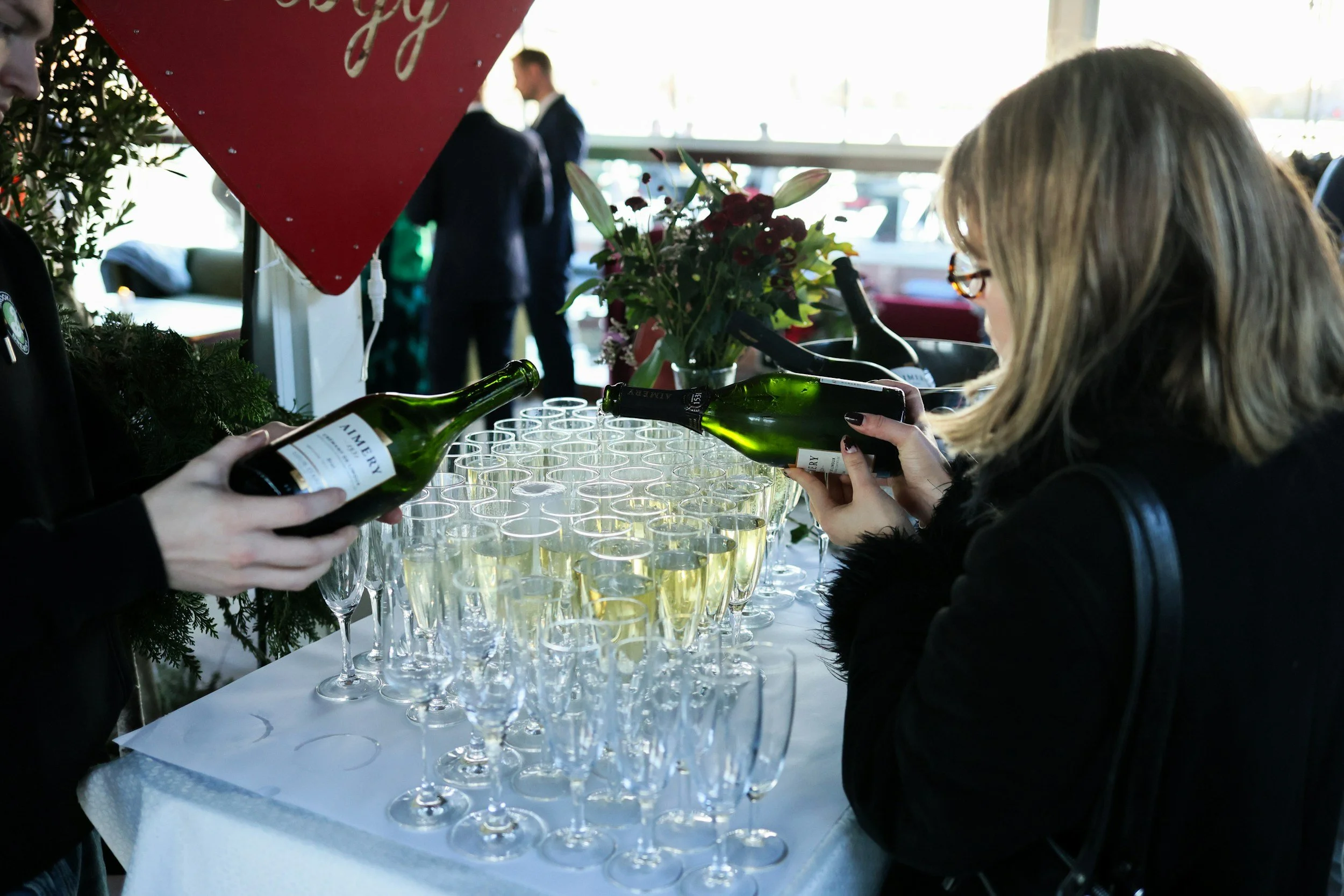 Champagne being poured into glasses at a corporate wine tasting event for team building