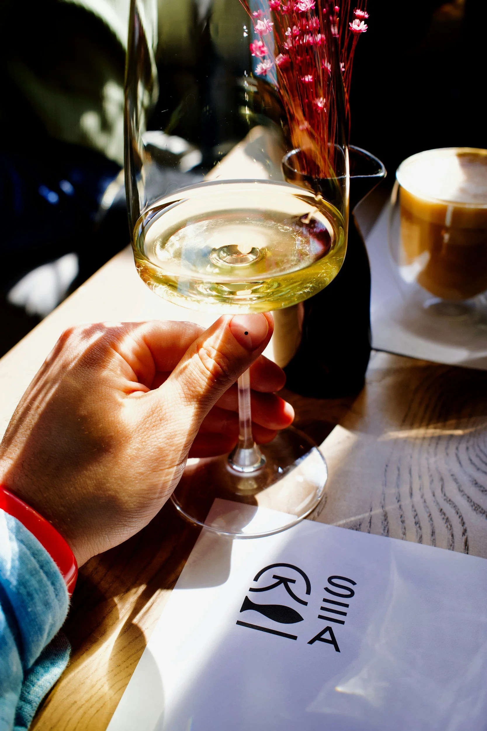 Glass of chilled white wine served during a summer wine drinking experience outdoors