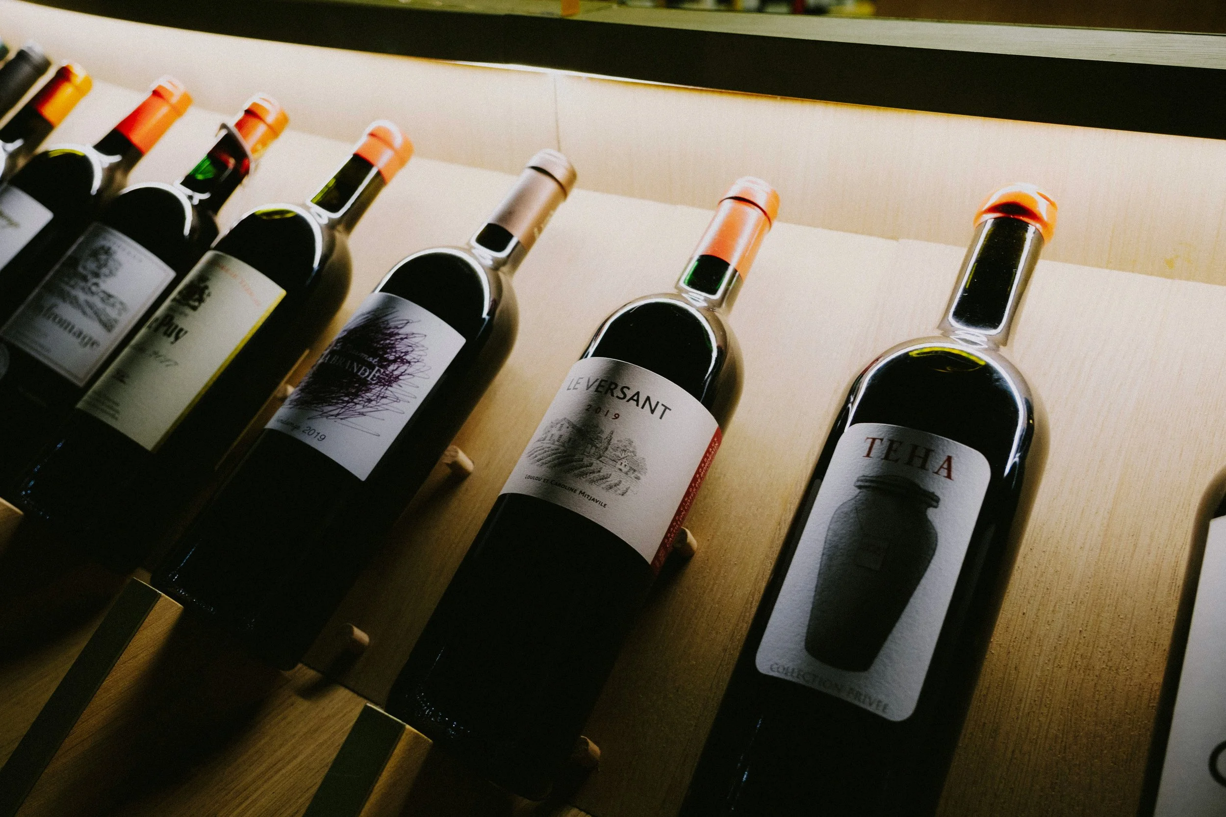 A selection of wine bottles displayed for choosing the right number of bottles for a home wine tasting.