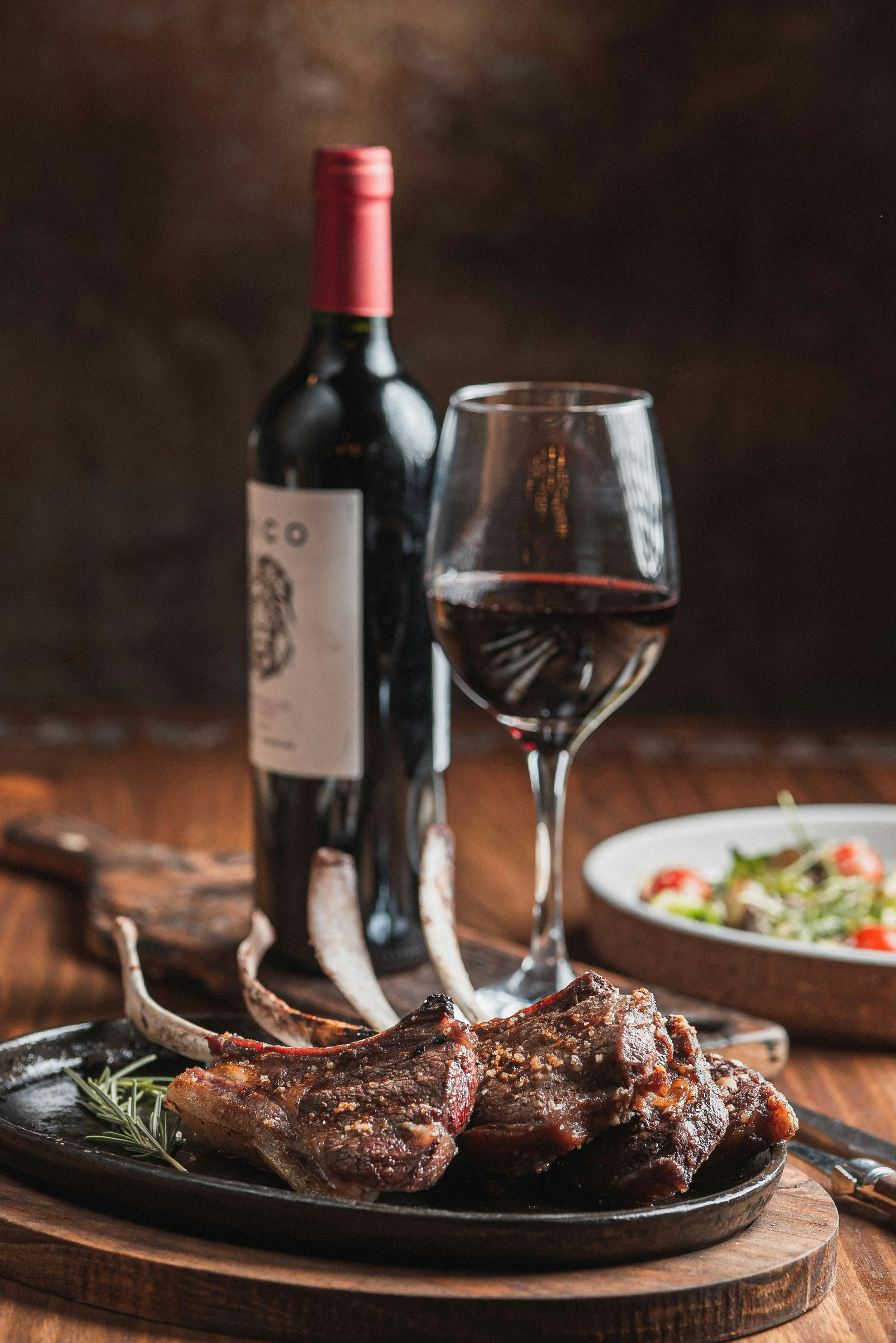 Grilled meat served with red wine for a barbecue wine pairing