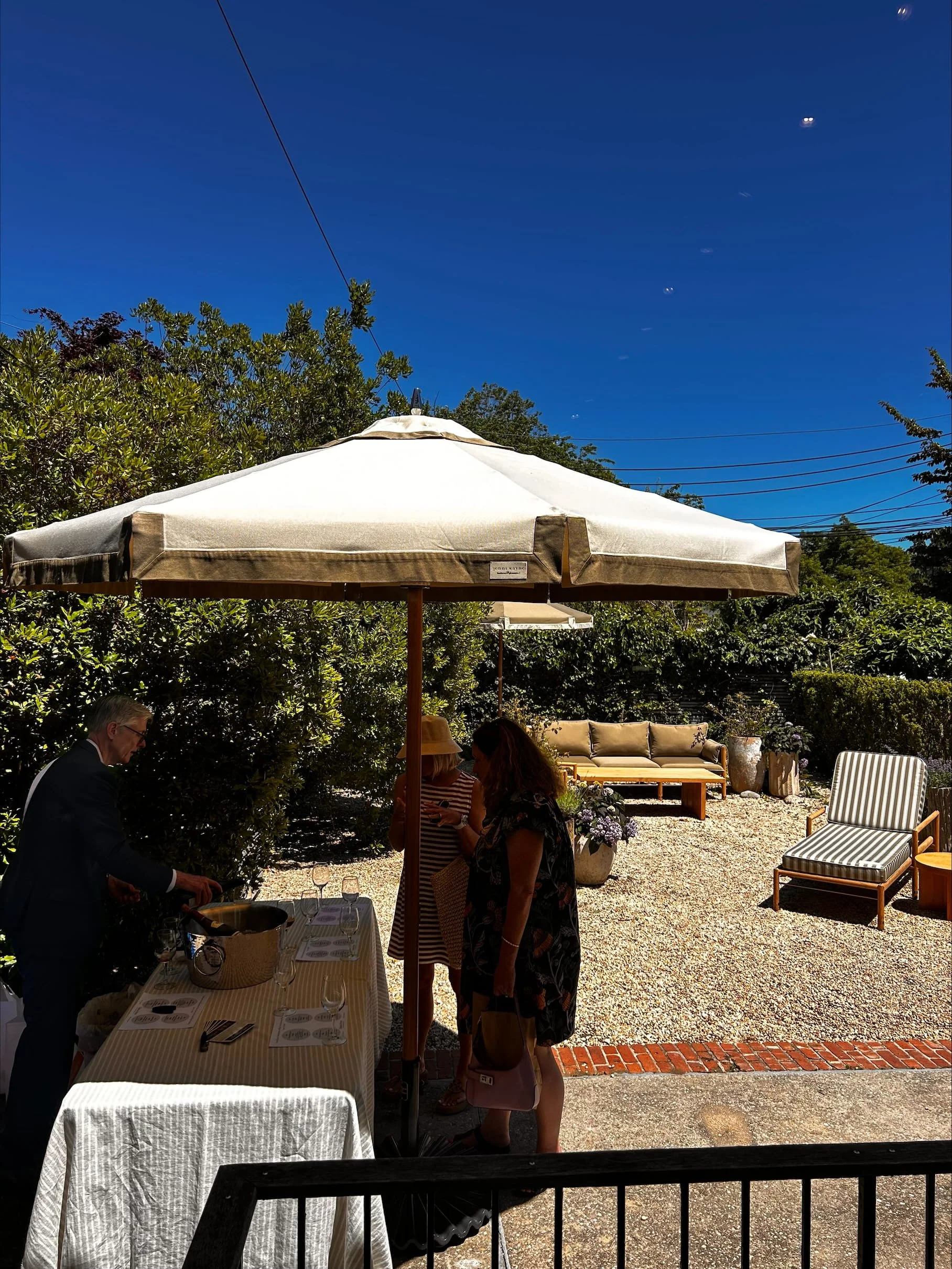 Guests enjoying a private wine tasting by Urban Pour Tastings at the Jenni Kayne Southampton anniversary celebration in the Hamptons.