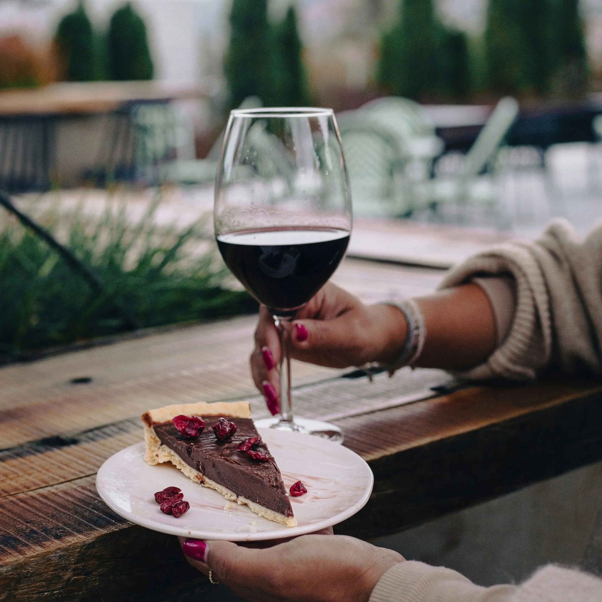 Glass of red wine served with a chocolate dessert during an elegant dessert and wine pairing experience
