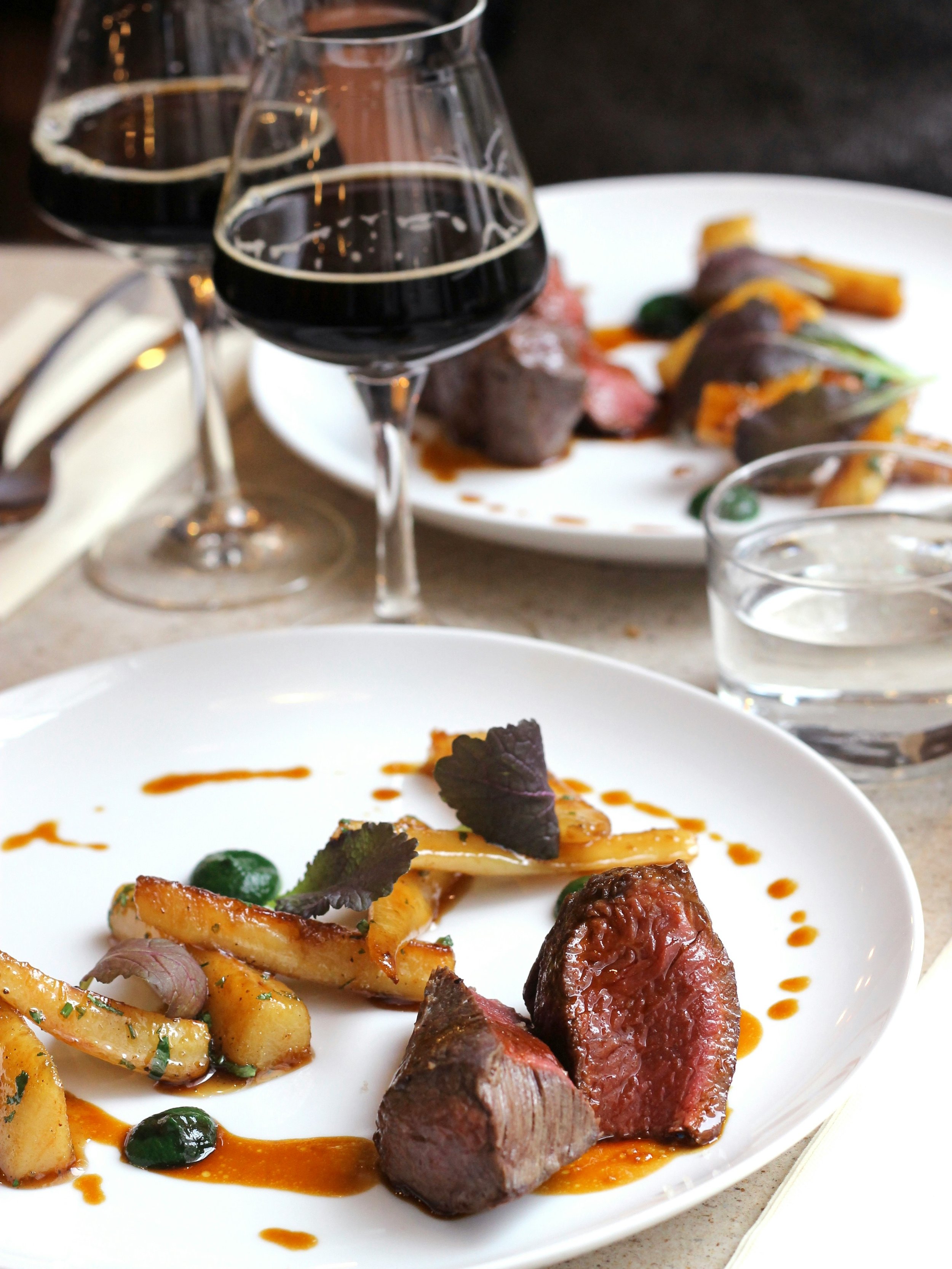 Red wine served with an elegant steak dinner during a fine dining wine and food pairing experience