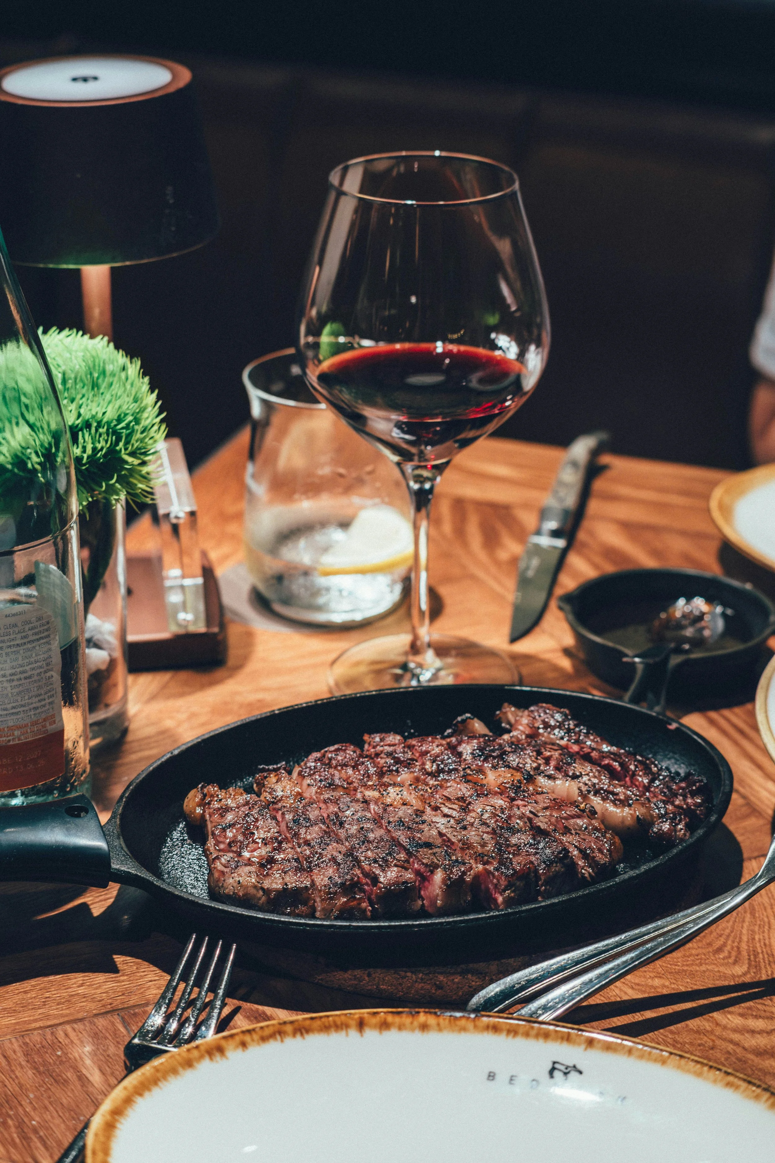Grilled steak served with a glass of red wine during an elegant wine and food pairing dinner
