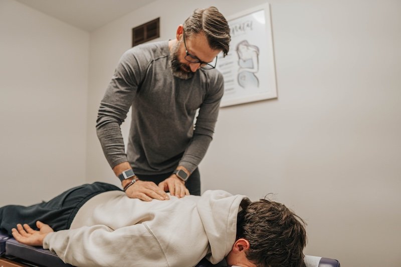 Chiropractor Dr. Jeremy Lawson performing adjustment on patient