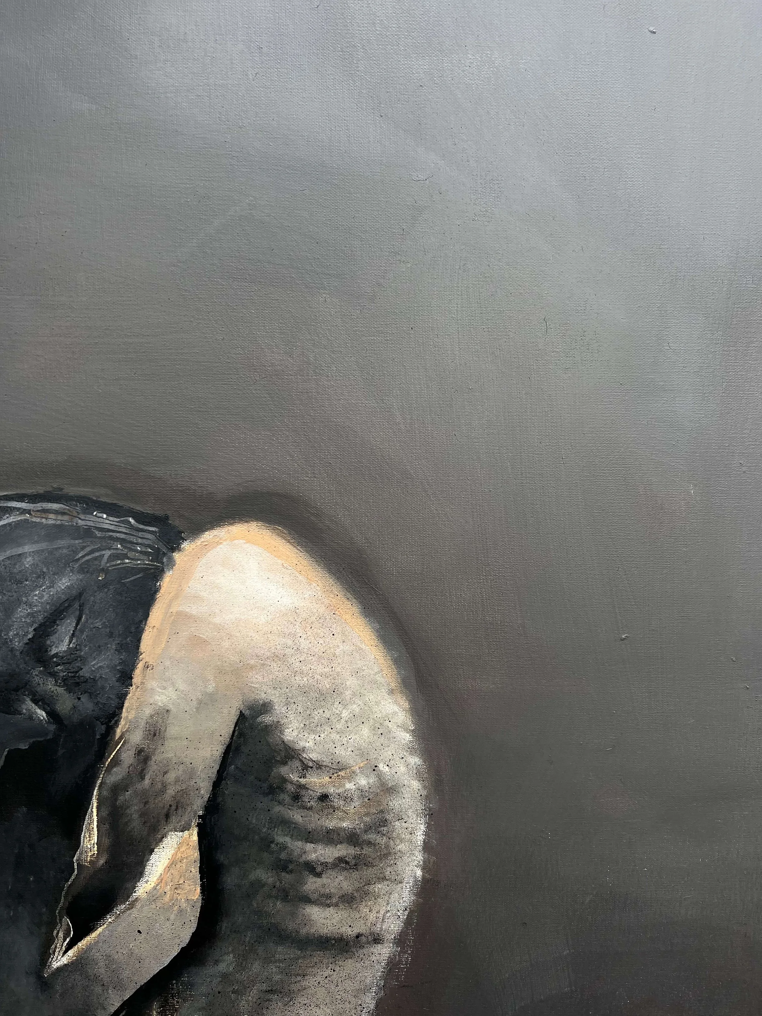 Close-up of Alienated contemporary painting highlighting muted grey tones and expressive figurative form on canvas