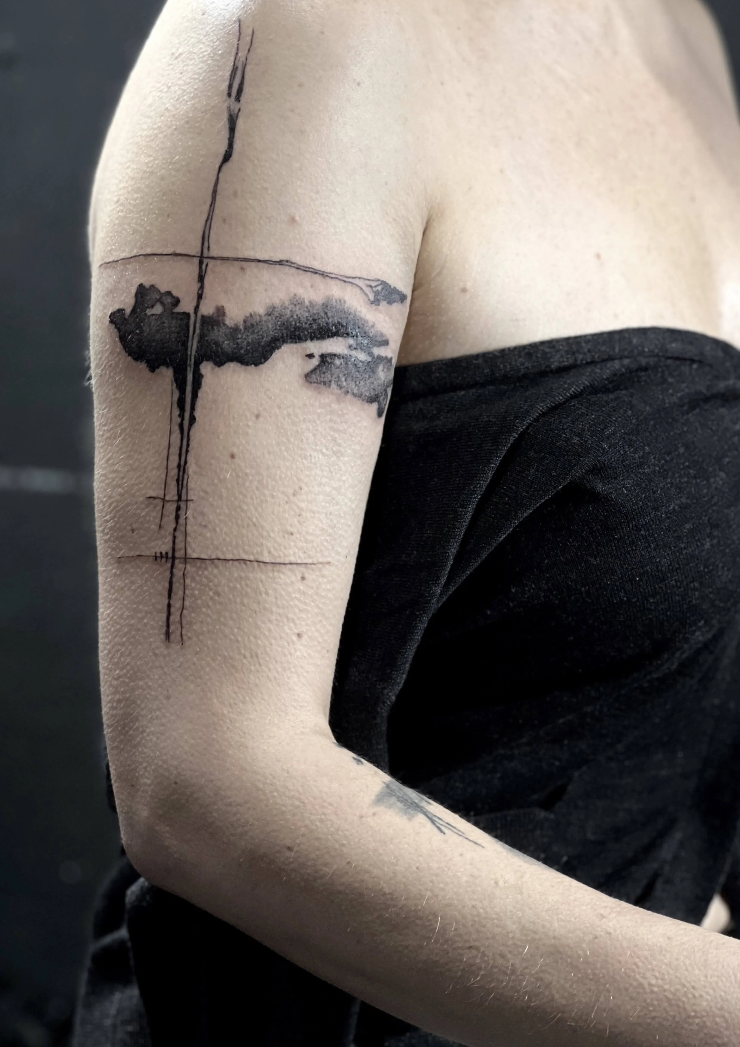 Contemporary black ink composition with geometric grid elements and soft shading.