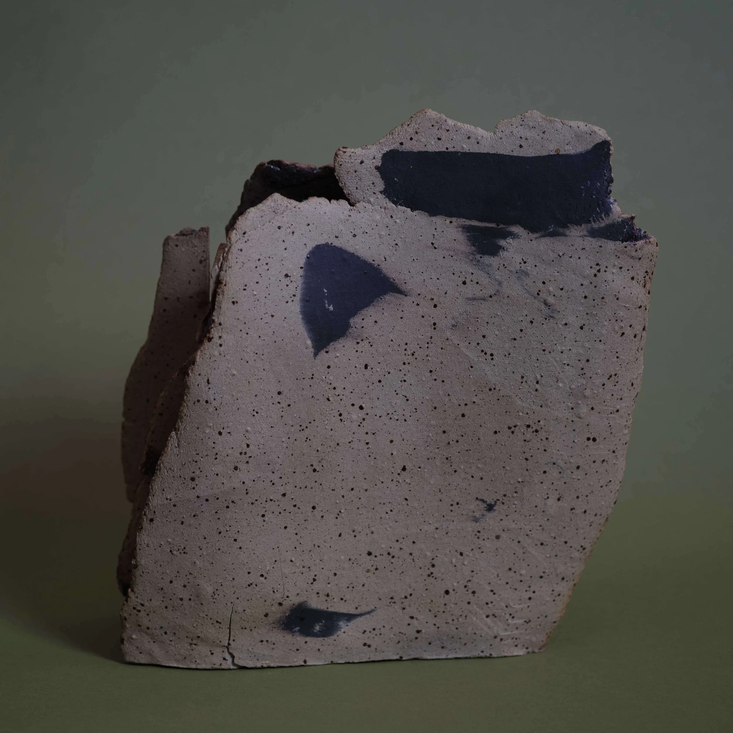 Side view of Mountain Vessel II sculptural ceramic piece showing layered clay structure and organic form