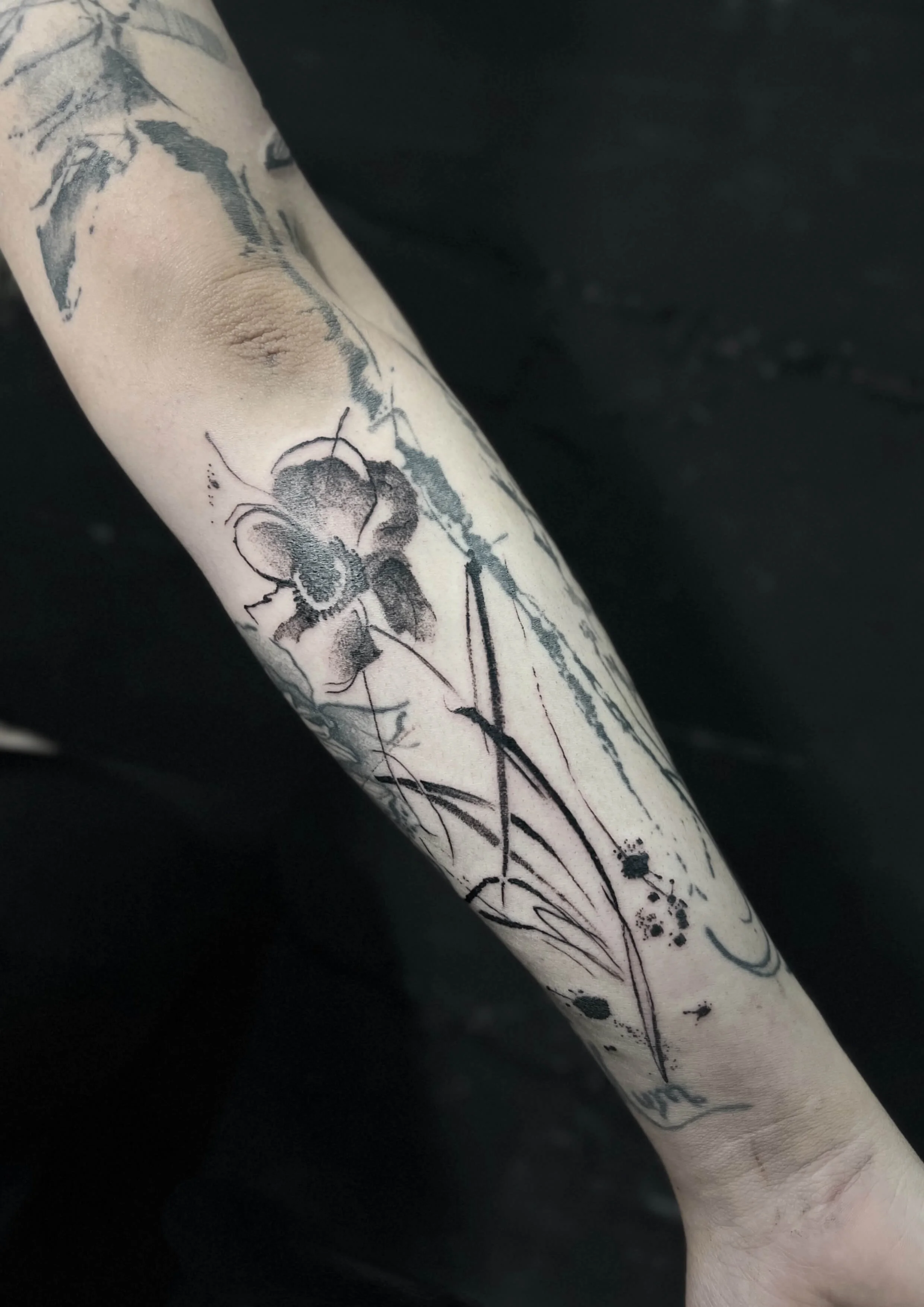 Contemporary flower design combining fine line detail and fluid ink textures.