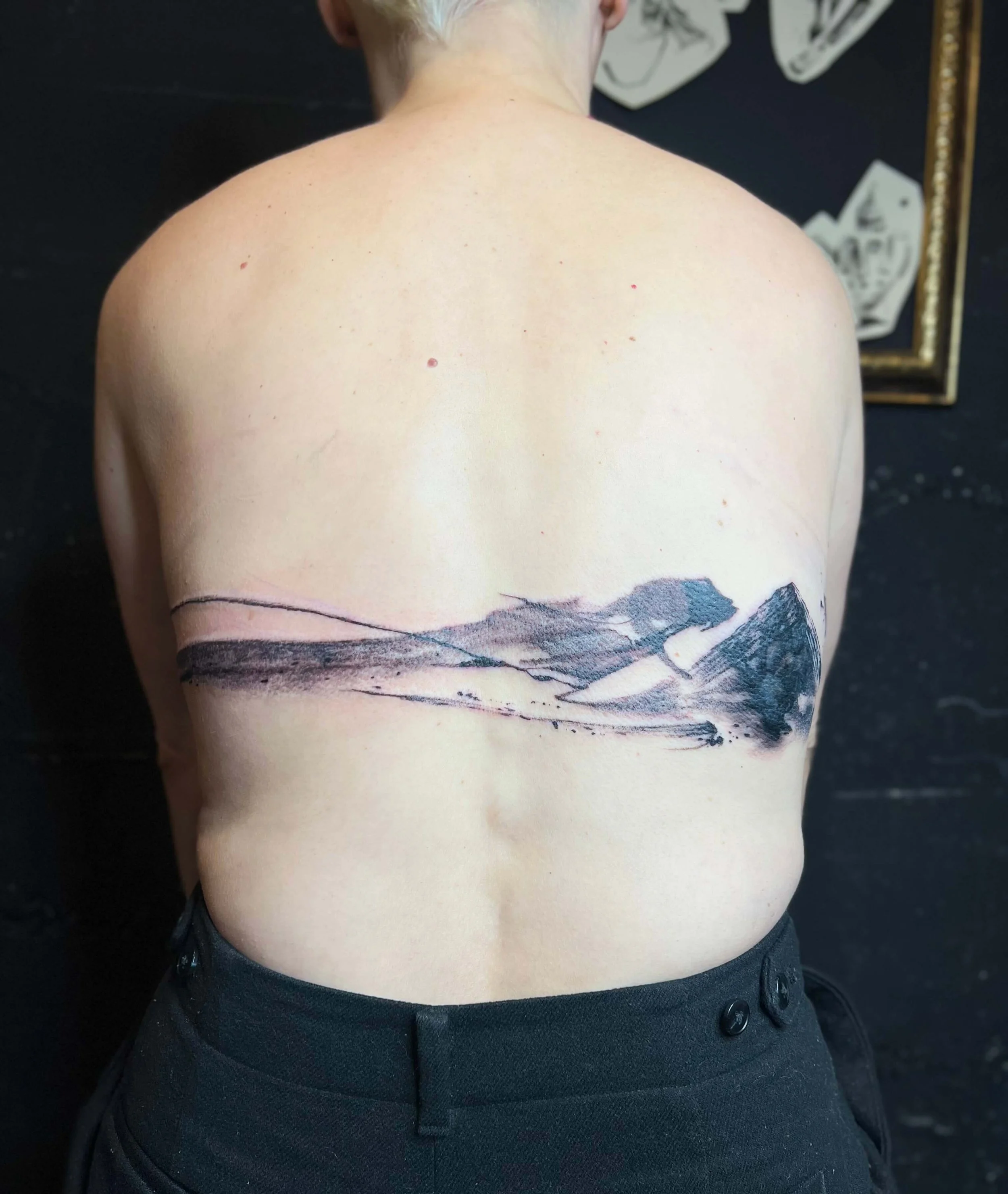 Expansive black ink landscape composition with layered mountain forms.