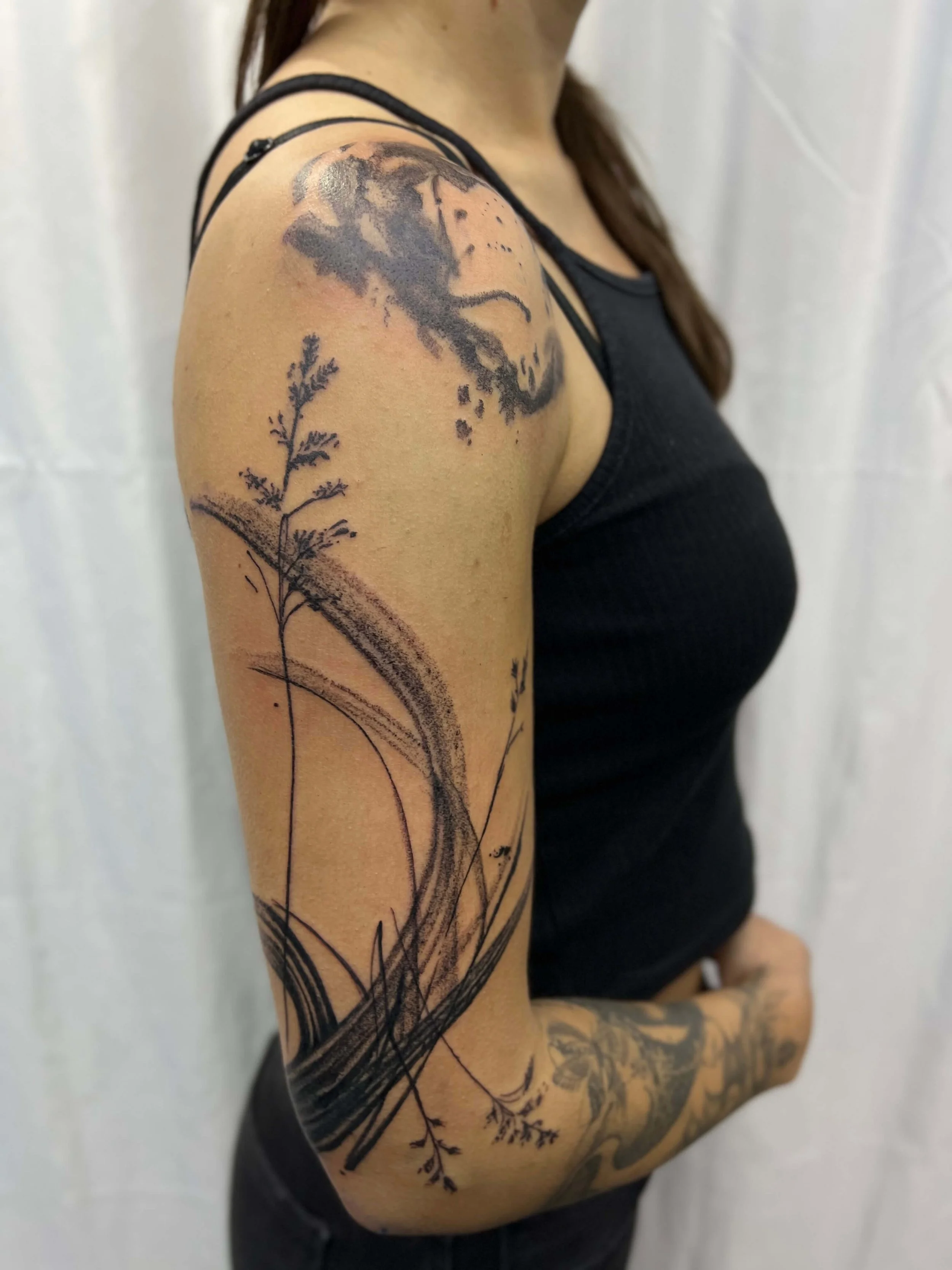 Contemporary blackwork sleeve featuring flowing abstract line composition.
